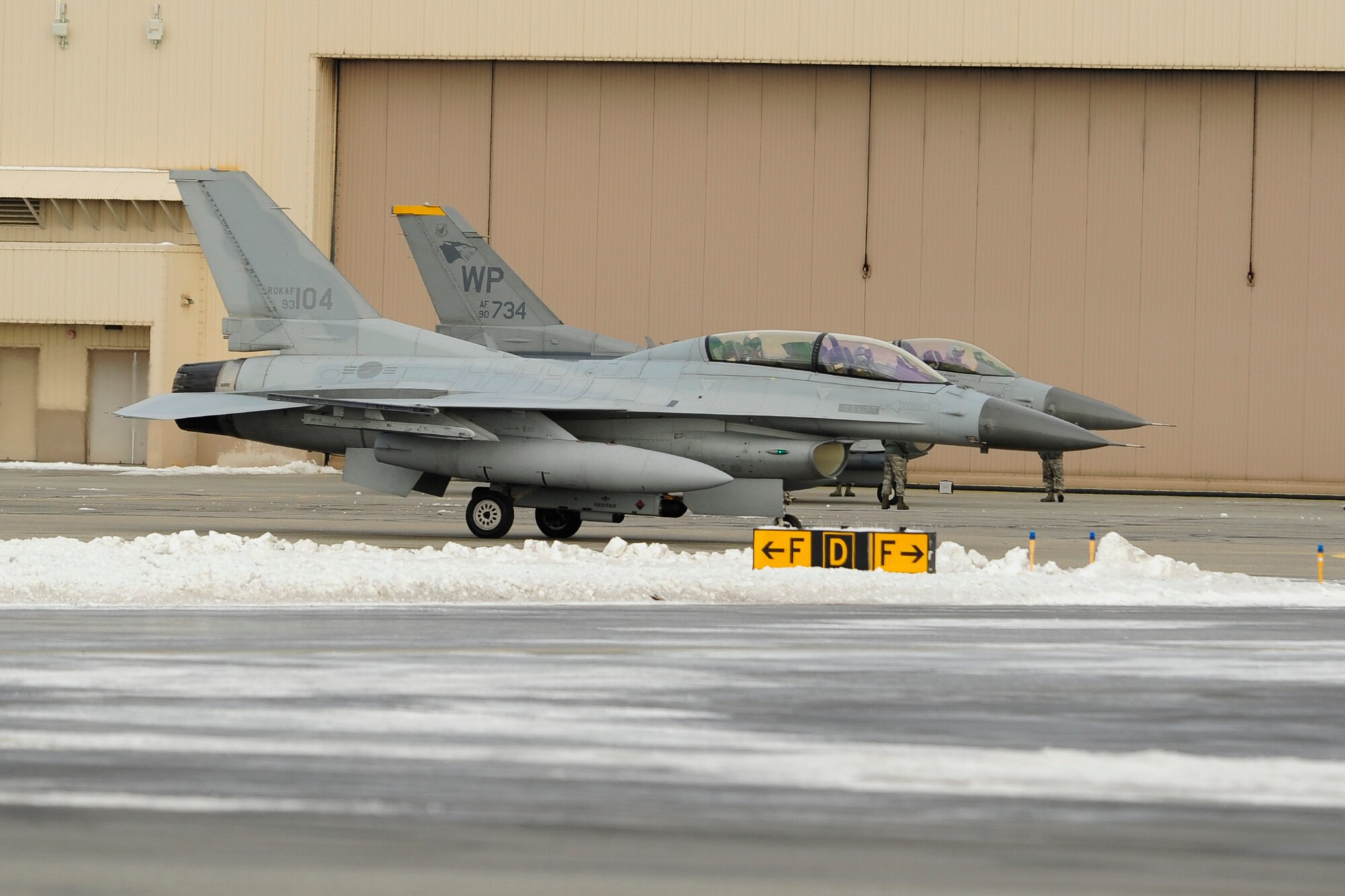 A South Korean KF-16 from Seosan Air Base, Republic of Korea, and an F-16 from Kunsan Air Base, ROK, taxi together during RED FLAG-Alaska 15-1 at Eielson Air Force Base, Alaska, Oct. 9, 2014. This field training exercise marks the first time ROK Air Force’s KF-16s have flown off of the Korean peninsula and is also their first time participating in RF-A. This exercise provides unique opportunities to integrate various forces into joint, coalition and multilateral training from simulated forward operating bases. (U.S. Air Force Photo by Senior Airman Taylor Curry/Released)