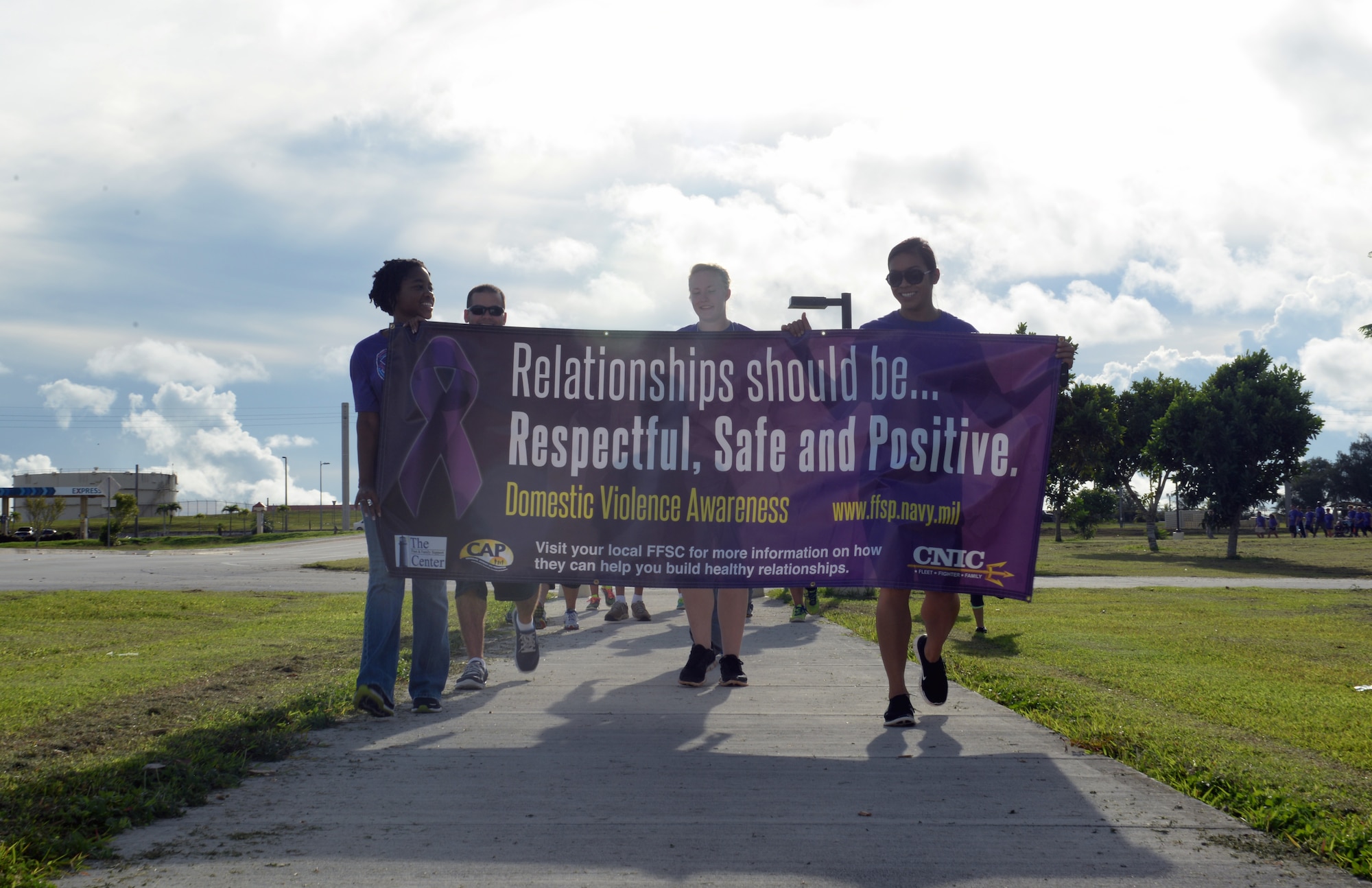 Members of the 36th Medical Group, family advocacy program, lead an Awareness Walk for Domestic Violence Awareness and Prevention month Oct. 16, 2014, on Andersen Air Force Base, Guam. The walk was one of three events hosted by the program and focused on the “Safe” aspect of the theme, “Relationships Should be Safe, Respectful and Positive”. (U.S. Air Force photo by Airman 1st Class Amanda Morris/Released)