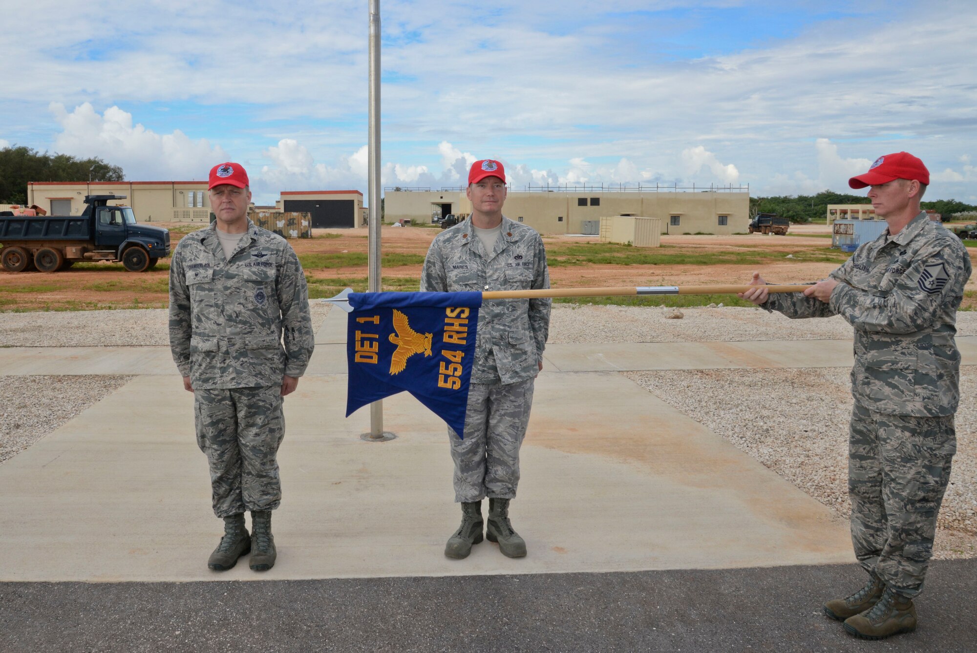 Master Sgt. Michael English, 554th RED HORSE Squadron NCO in charge of emergency management, unfurls the flag Oct. 15, 2014, during the opening ceremony of Silver Flag on Northwest Field at Andersen Air force Base, Guam.  Silver Flag training is designed to setup operations at bare-base locations and features bed down planning, base recovery, command and control and airfield recovery. (U.S. Air Force photo by Staff Sgt. Robert Hicks/Released)