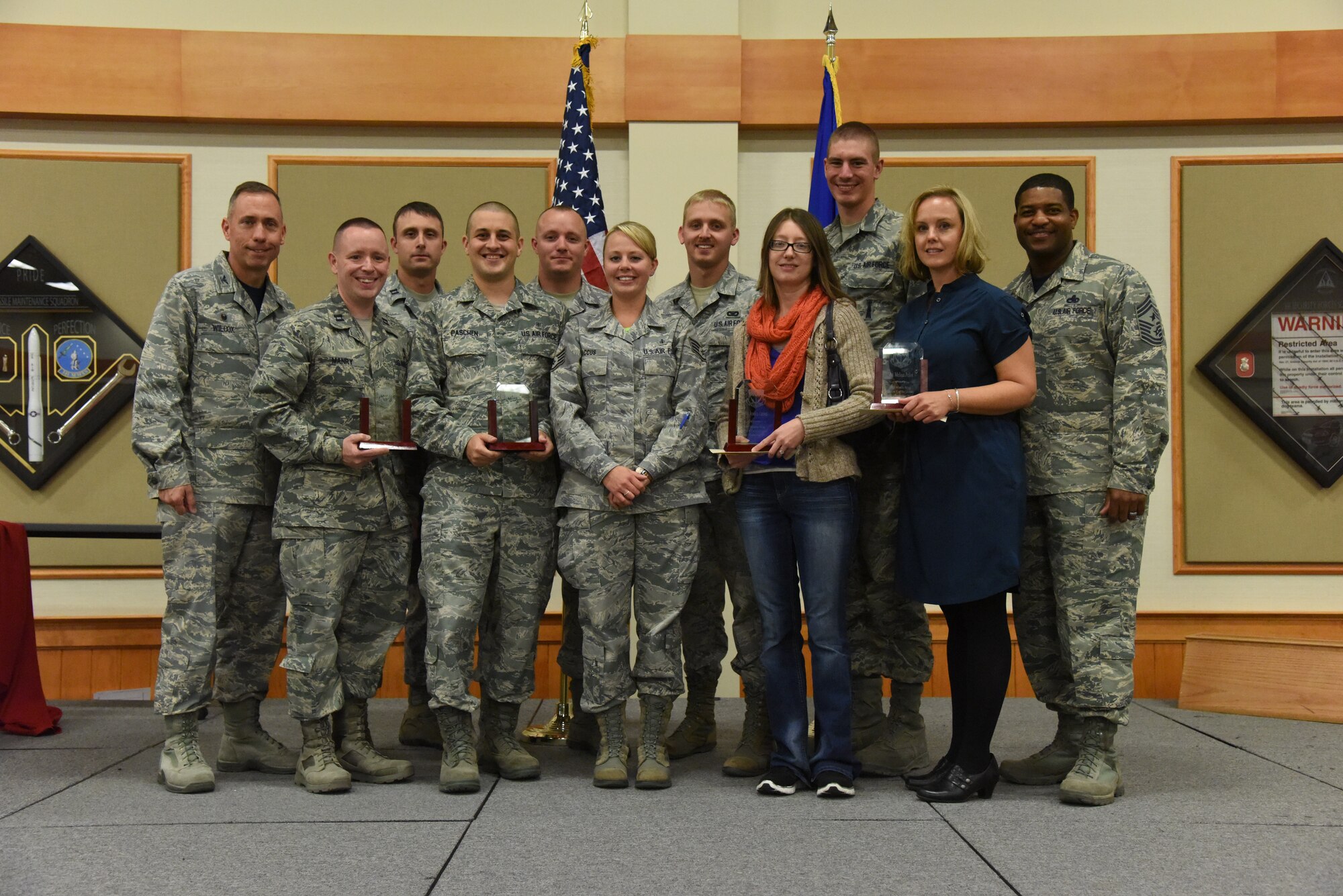 Winners of this quarter’s Wing Quarterly Awards pose for a photo at the Grizzly Bend on Oct. 17. Pictured from left to right are: Col. Tom Wilcox, 341st Missile Wing commander; Company Grade Officer of the Quarter, Capt. Keith Manry, 341st MW; 341st MW Professional Team, Capt. Jason Garcia, Staff Sgt. Lee Paschen, Staff Sgt. Justin Bloomfield, Staff Sgt. Leslie Baccus, 341st Medical Support Support Squadron Diagnostics and Therapeutics Flight; Airman of the Quarter, Senior Airman Kyle Carpenter, 341st Security Forces Group; Civilian Category I, Jessica Gaines, 341st MSS; Honor Guard of the Quarter, Senior Airman Aaron Billings, Bravo Flight; Civilian Category II, Melissa Pellot, 341st Medical Group; Chief Master Sgt. Phillip Easton, 341st MW command chief. Not pictured:  Non Commissioned Officer of the Quarter, Tech. Sgt. Bethany West, 341st Mission Support Group. Senior Non Commissioned Officer of the Quarter, Master Sgt. Marcus Grant, 341st MSG; Civilian Category I Sup, Gary Martin, 341st MSG; Civilian Category II Supervisory, Mark Jefferson, 341st MSG; Volunteer, Master Sgt. Diane Schmitt, 819th RED HORSE Squadron; 341st MW Professional Team, Staff Sgt. Jonathon Baker, Geoff Fallon, Senior Airman Monik Hicks, Lee Weideman. (U.S. Air Force photo/Airman 1st Class Collin Schmidt) 