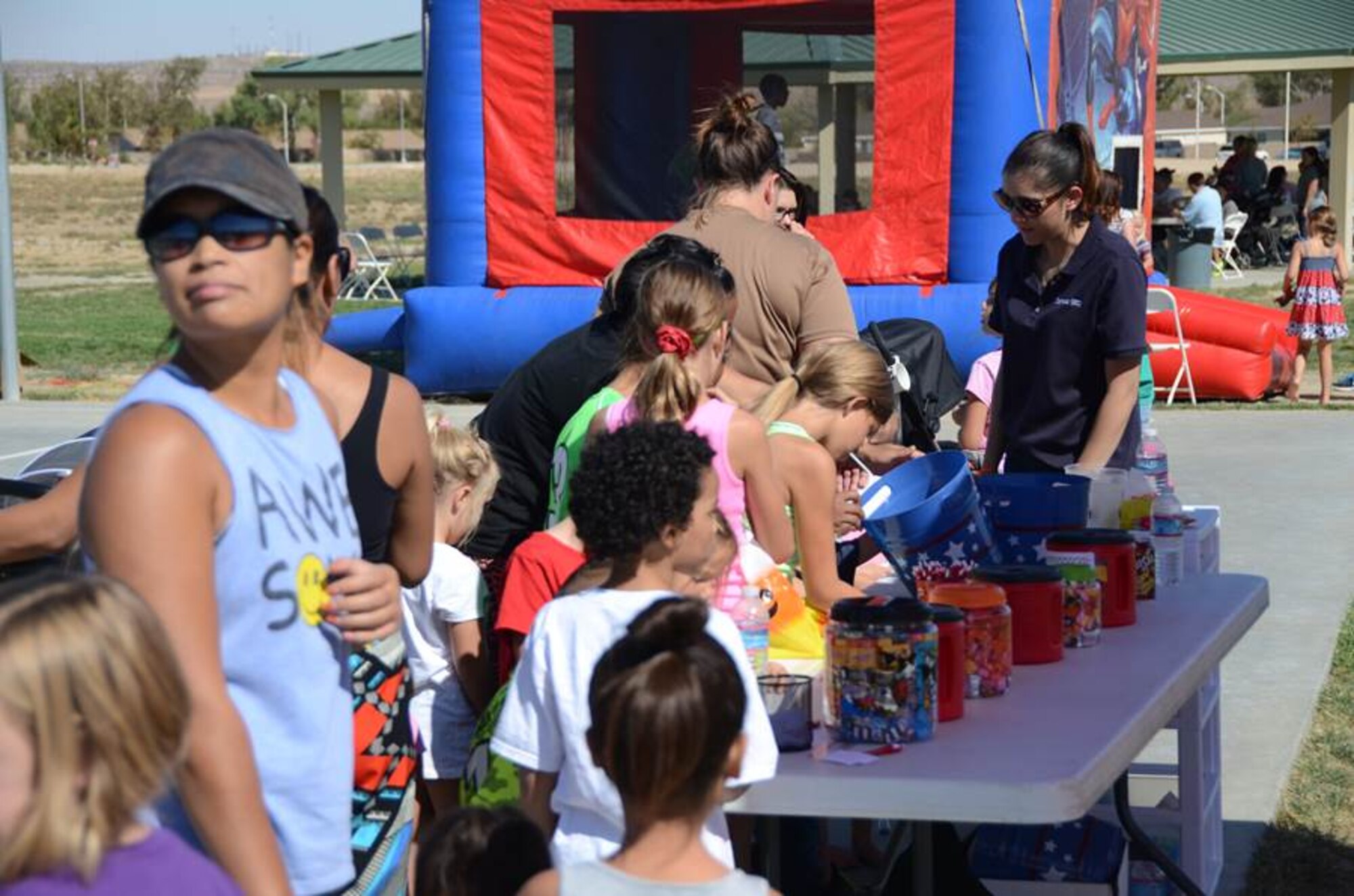 Military families guess the amount of candy in jars for big prizes at the second annual Fallapalooza at Edwards AFB. More than 400 people turned out to enjoy free food, fun and prizes. The event was sponsored by Corvias Military Living at the Community Park on Saturday, October 18. (Courtesy photo by Mark Nettles, Corvias Military Living)