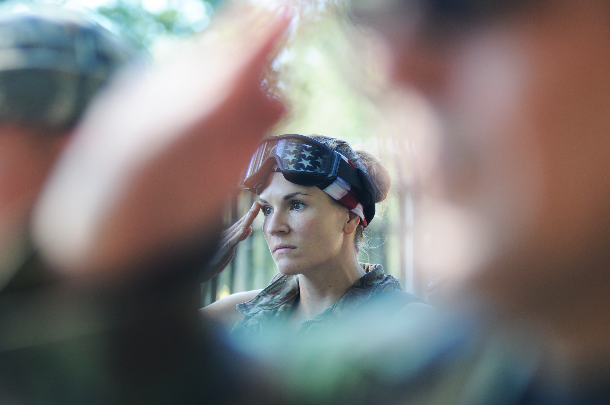 Staff Sgt. Anna Lee, 85th Engineering Installation Squadron, renders a salute during the playing of the National Anthem during the 85th EIS Combat Dining-In Oct. 17, 2014, at Maltby Hall, Keesler Air Force Base, Miss.  The Combat Dining-In is a military tradition that promotes camaraderie and esprit de corps throughout the ranks. (U.S. Air Force photo by Kemberly Groue)