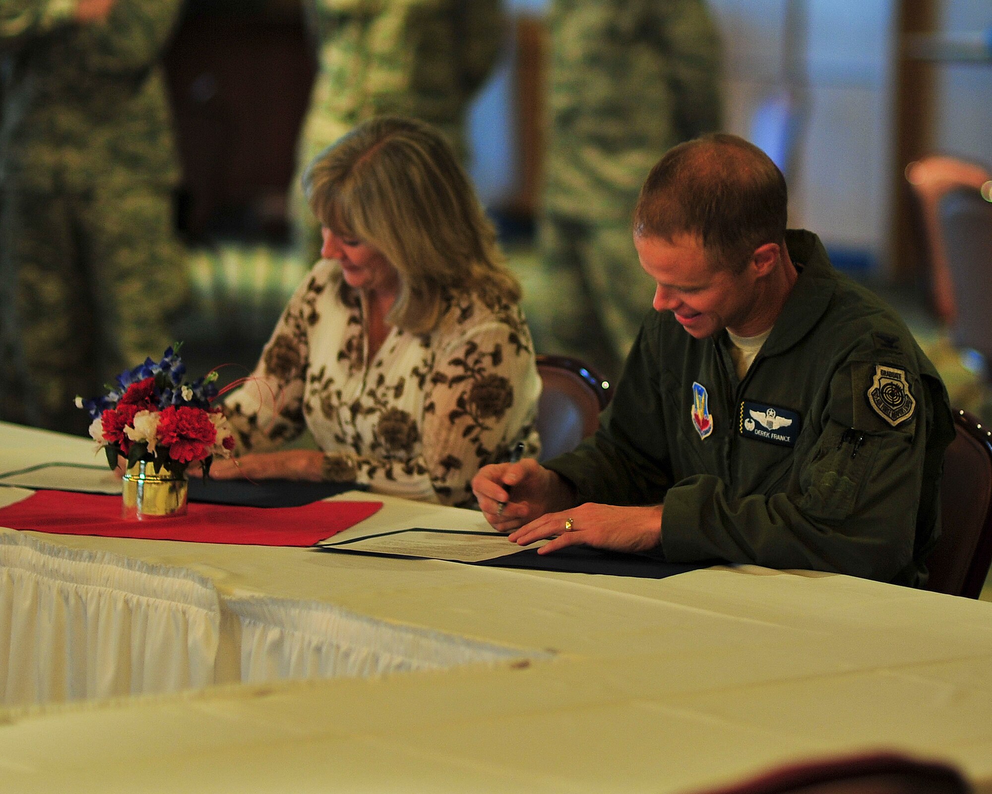Col. Derek C. France, 325th Fighter Wing commander, and Kimberly Bodine, Career Source Gulf Coast executive director, sign documents during a P4, Public-Public; Public-Private Partnership, meeting  which will allow information to be shared between Tyndall and CareerSource Florida Oct. 9. This will allow employers to more effectively recruit potential employees and increase the opportunities for veterans to transfer their military skills to the civilian world. (U.S. Air Force photo by Airman 1st Class Dustin Mullen)