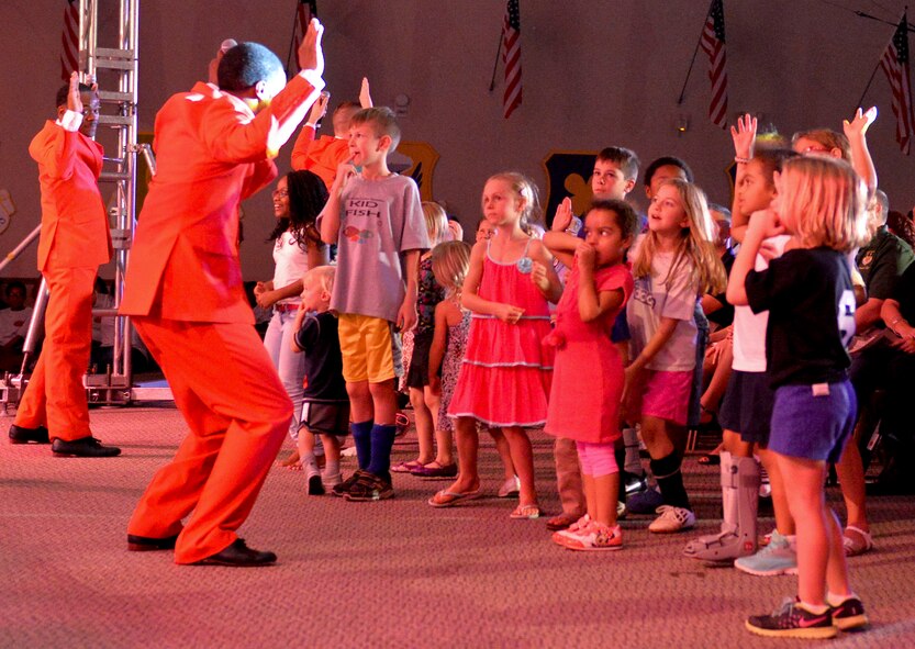 Air Force Tops in Blue members interact with children in the audience on Barksdale Air Force Base, La., Oct. 16, 2014. Tops in blue promotes community relations, supporting recruiting efforts and serves as ambassadors for the United States of America and the Air Force. (U.S. Air Force Photo/Airman 1st Class Mozer O. Da Cunha)