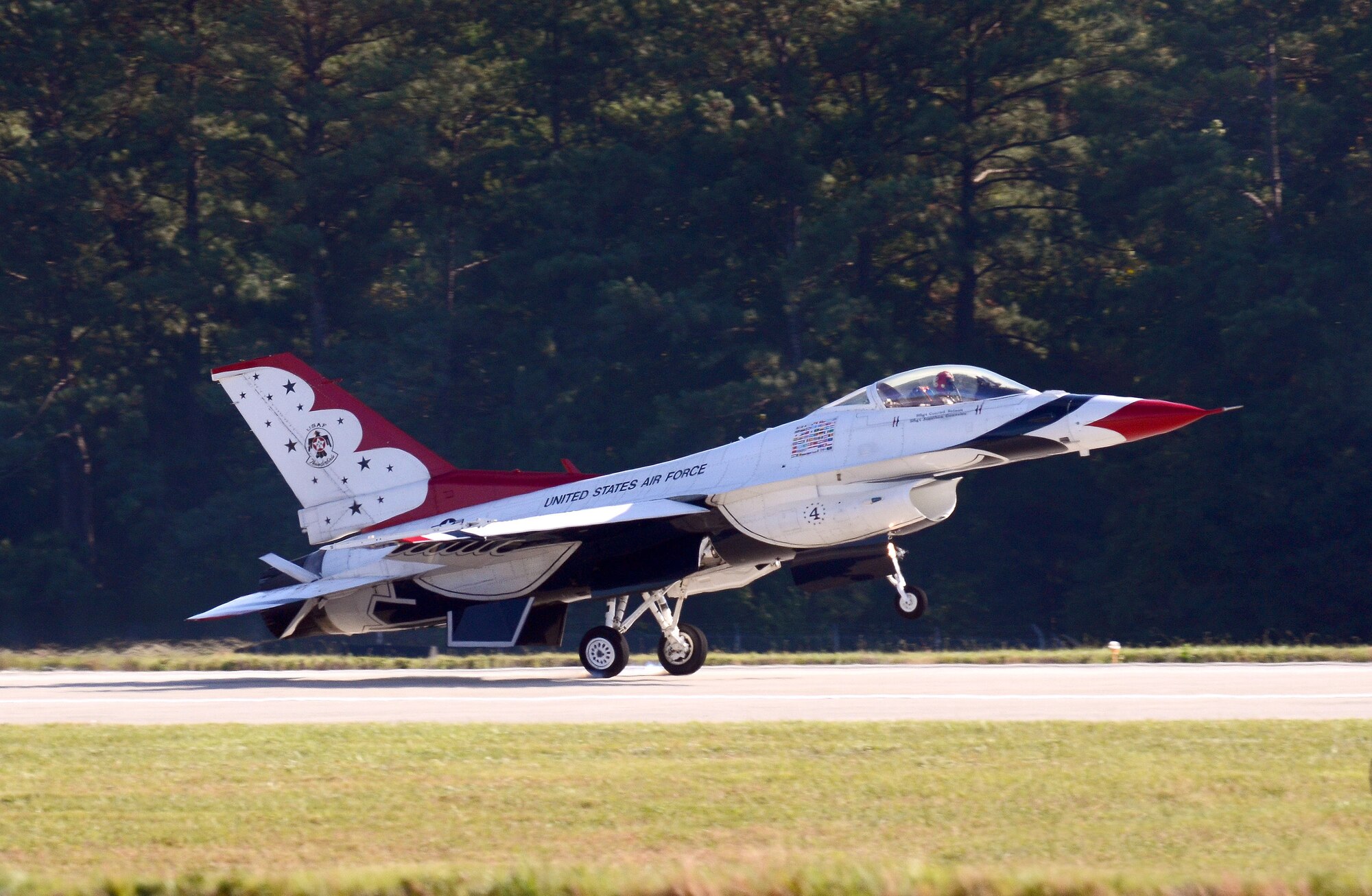 Thunderbird #4, Maj. Curtis Dougherty, flying the slot in the diamond formation, returns to Dobbins Air Reserve Base from the Wings Over North Georgia air show Oct. 18, 2014. The USAF Air Demonstration Squadron Thunderbirds are using Dobbins as their base of operations for their performances at the air show this weekend at the Russell Regional Airport in Rome, Georgia. (U.S. Air Force photo/ Brad Fallin/Released)