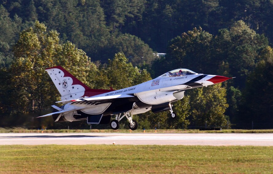 Thunderbird #4, Maj. Curtis Dougherty, flying the slot in the diamond formation, returns to Dobbins Air Reserve Base from the Wings Over North Georgia air show Oct. 18, 2014. The USAF Air Demonstration Squadron Thunderbirds are using Dobbins as their base of operations for their performances at the air show this weekend at the Russell Regional Airport in Rome, Georgia. (U.S. Air Force photo/ Brad Fallin/Released)