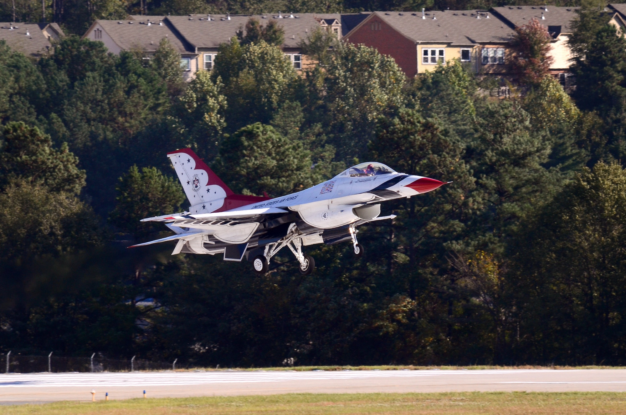 Thunderbird #4, Maj. Curtis Dougherty, flying the slot in the diamond formation, returns to Dobbins Air Reserve Base from the Wings Over North Georgia air show Oct. 18, 2014. The USAF Air Demonstration Squadron Thunderbirds are using Dobbins as their base of operations for their performances at the air show this weekend at the Russell Regional Airport in Rome, Georgia. (U.S. Air Force photo/ Brad Fallin/Released)