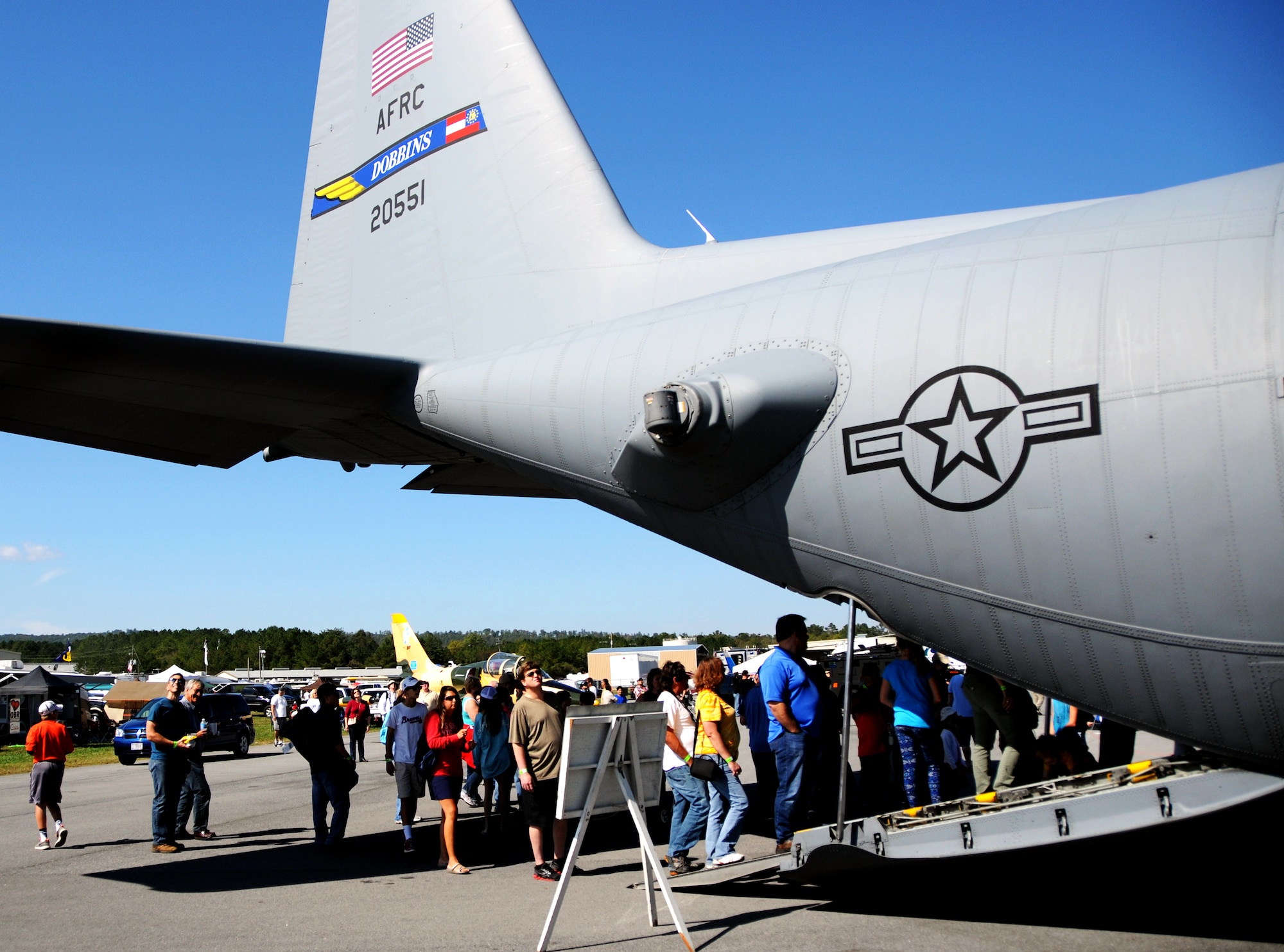 Visitors to the Wing over North Georgia air show line up to tour the bay area of a U.S. Air Force C-130 Hercules from Dobbins Air Reserve Base, Ga. at Rome, Ga., Oct. 18, 2014. The 700th Airlift Squadron brought a U.S. Air Force C-130 Hercules to the WONG air show as a static display. (U.S. Air Force photo by Senior Airman Daniel Phelps/Released)