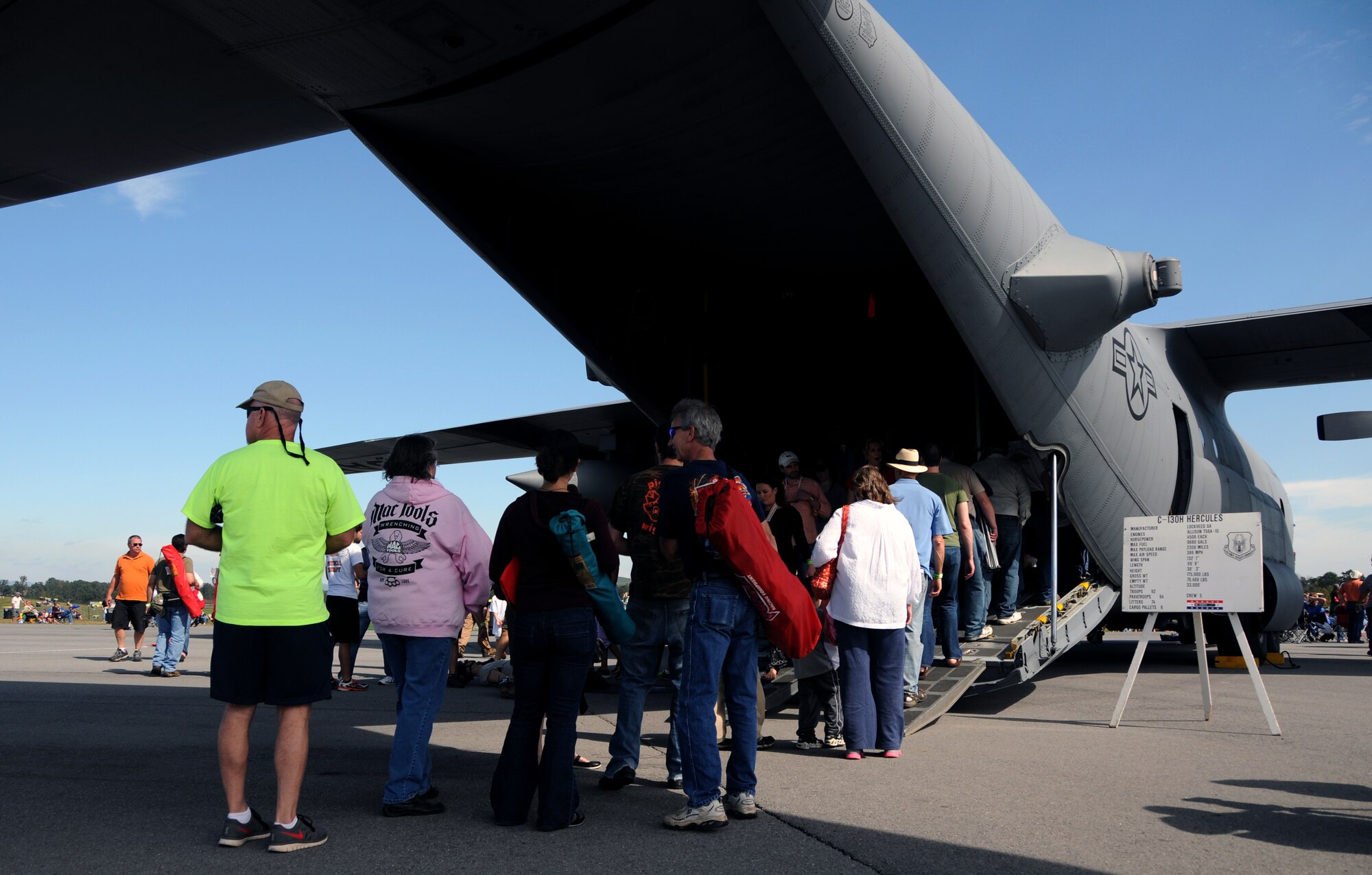 Visitors to the Wing over North Georgia air show line up to tour a U.S. Air Force C-130 Hercules from Dobbins Air Reserve Base, Ga. at Rome, Ga., Oct. 18, 2014. The 700th Airlift Squadron brought a U.S. Air Force C-130 Hercules to the WONG air show as a static display. (U.S. Air Force photo by Senior Airman Daniel Phelps/Released)