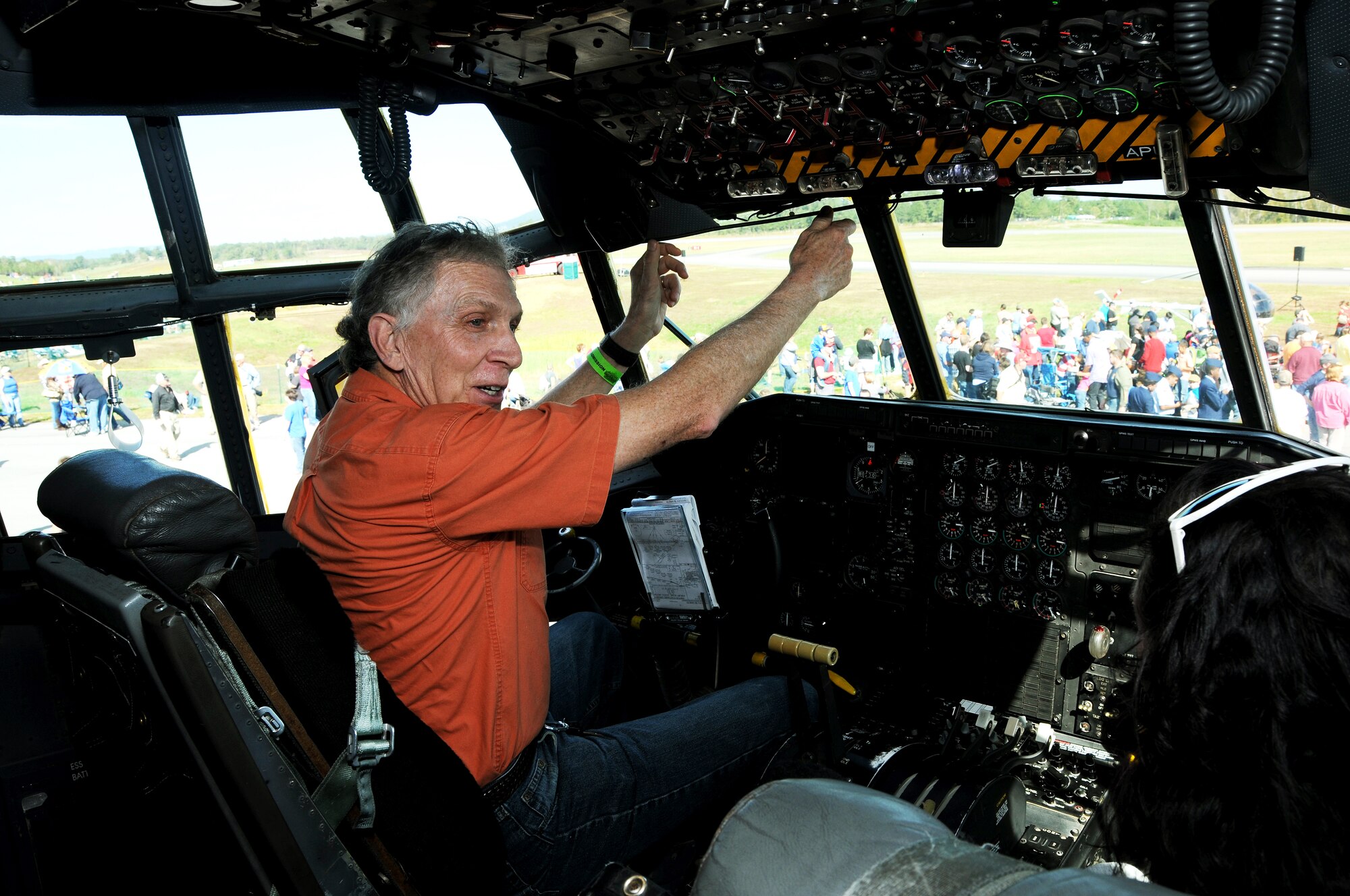 Brian Shuler, a Marietta, Ga. resident and former C-130 crew member, demonstrates differences between the one he flew in and the static from Dobbins Air Reserve Base at the Wings over North Georgia air show in Rome, Ga, Oct. 18, 2014. The 700th Airlift Squadron brought a U.S. Air Force C-130 Hercules to the WONG air show as a static display. (U.S. Air Force photo by Senior Airman Daniel Phelps/Released)