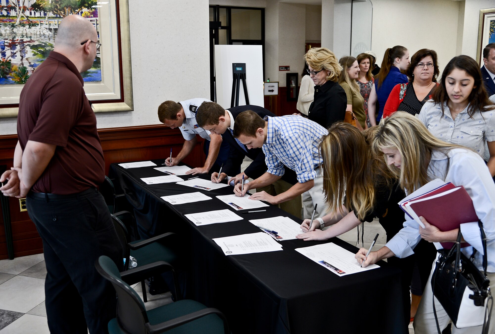 Students from various high schools throughout Tampa sign in during Academy Day at the Davis Conference Center on MacDill Air Force Base, Fla., Oct. 18, 2014. During the event, students in grades 9-12 listened to presentations by representatives from the respective military academies present. (U.S. Air Force photo by Senior Airman Vernon L. Fowler Jr./Released)