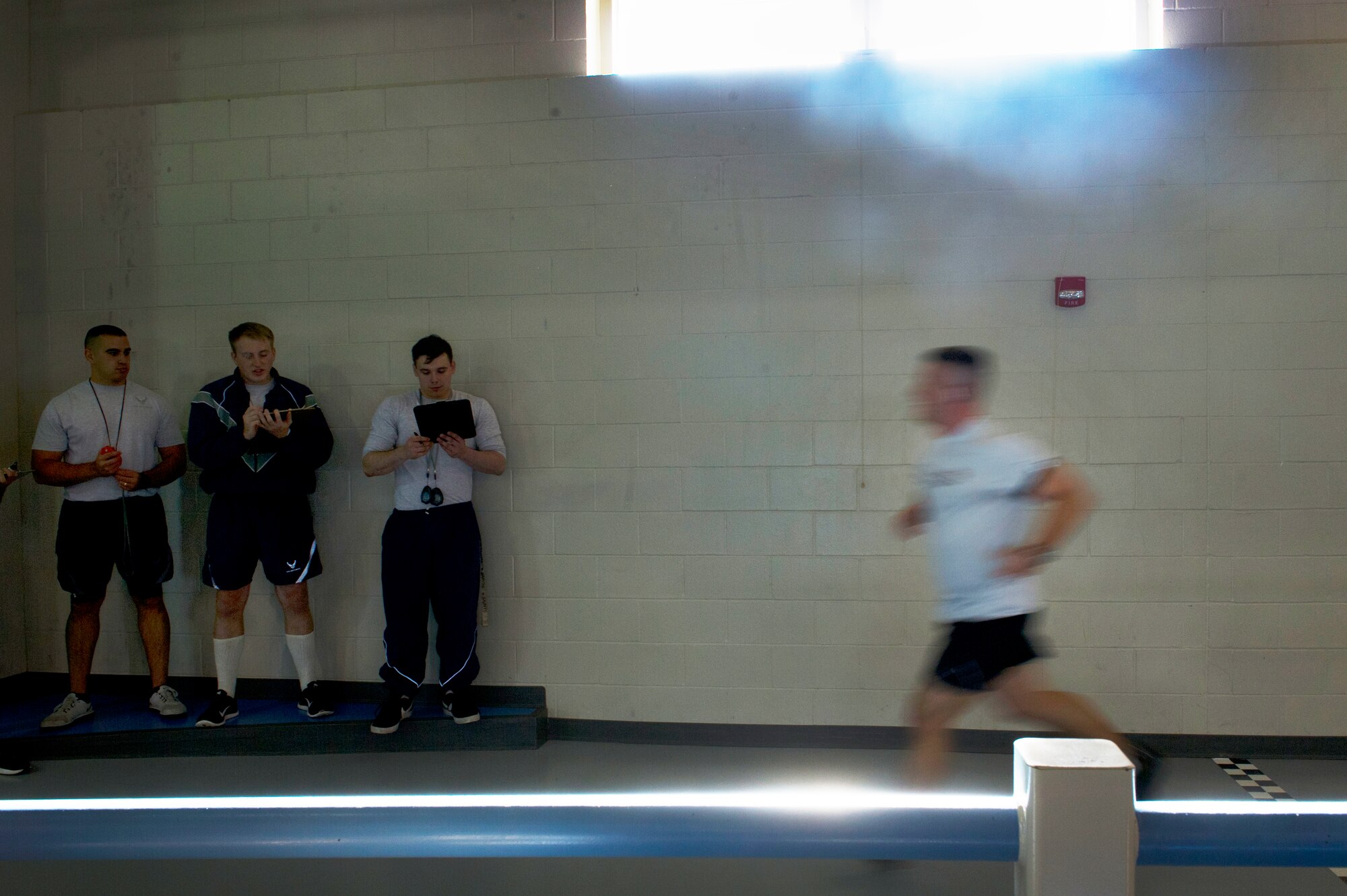 Physical training leaders record run times during the Iron Airman Challenge on Minot Air Force Base N.D., Oct. 10, 2014. Airmen have 30 minutes to complete a two-mile run along with as many push ups, sit ups and pull ups as they can. (U.S. Air Force photo/Senior Airman Brittany Y. Bateman)