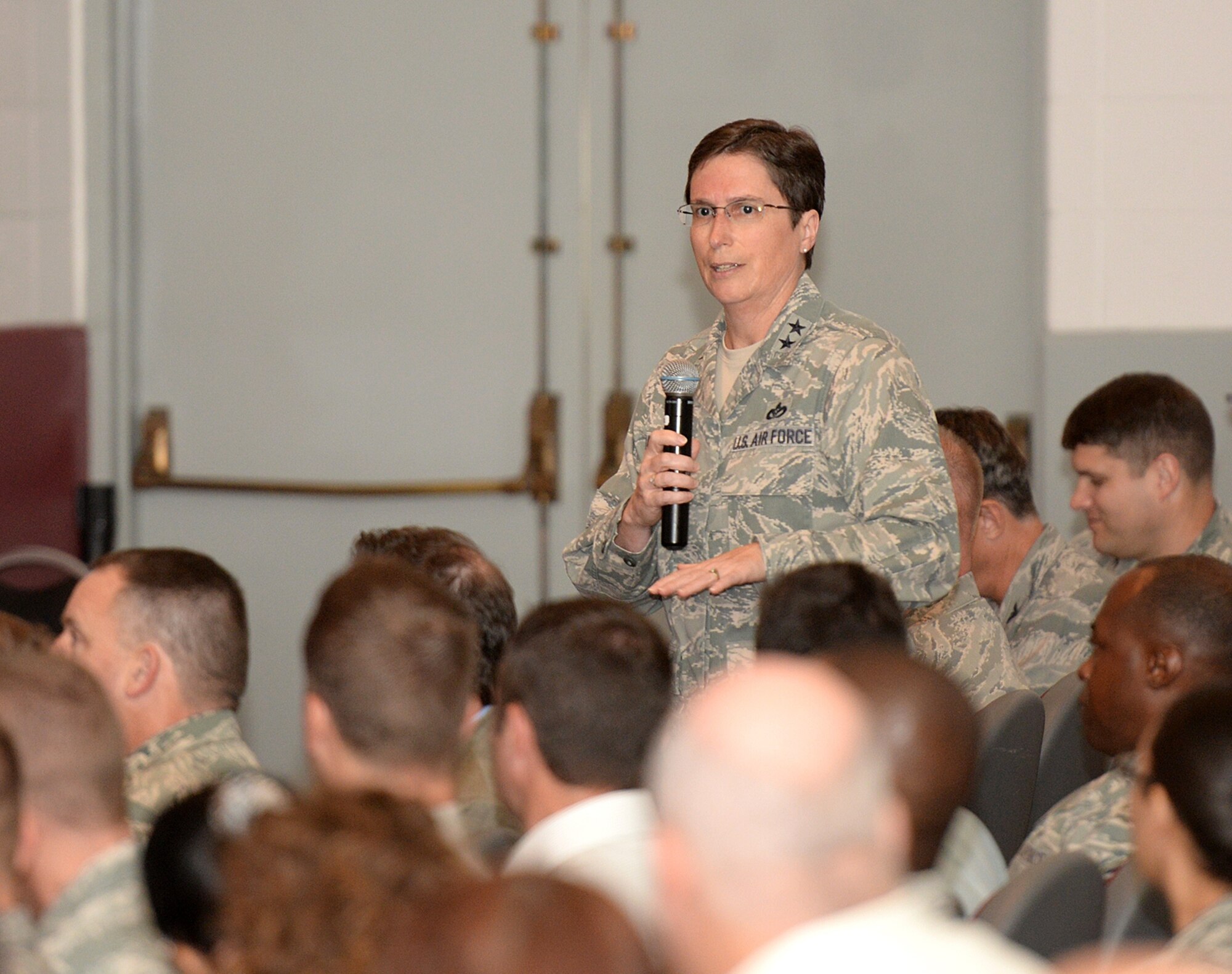 Maj. Gen. Theresa Carter, commander of the Air Force Installation and Mission Support Center (Provisional), presents information about the new unit to about 400 members of the Air Force Civil Engineer Center, Air Force Security Forces Center, Air Force Materiel Command Services Directorate and local squadrons assigned to the Air Force Installation Contracting Agency Oct. 9 at a town hall meeting in the Bob Hope Theater at Joint Base San Antonio-Lackland, Tex. (U.S. Air Force photo/Benjamin Faske)