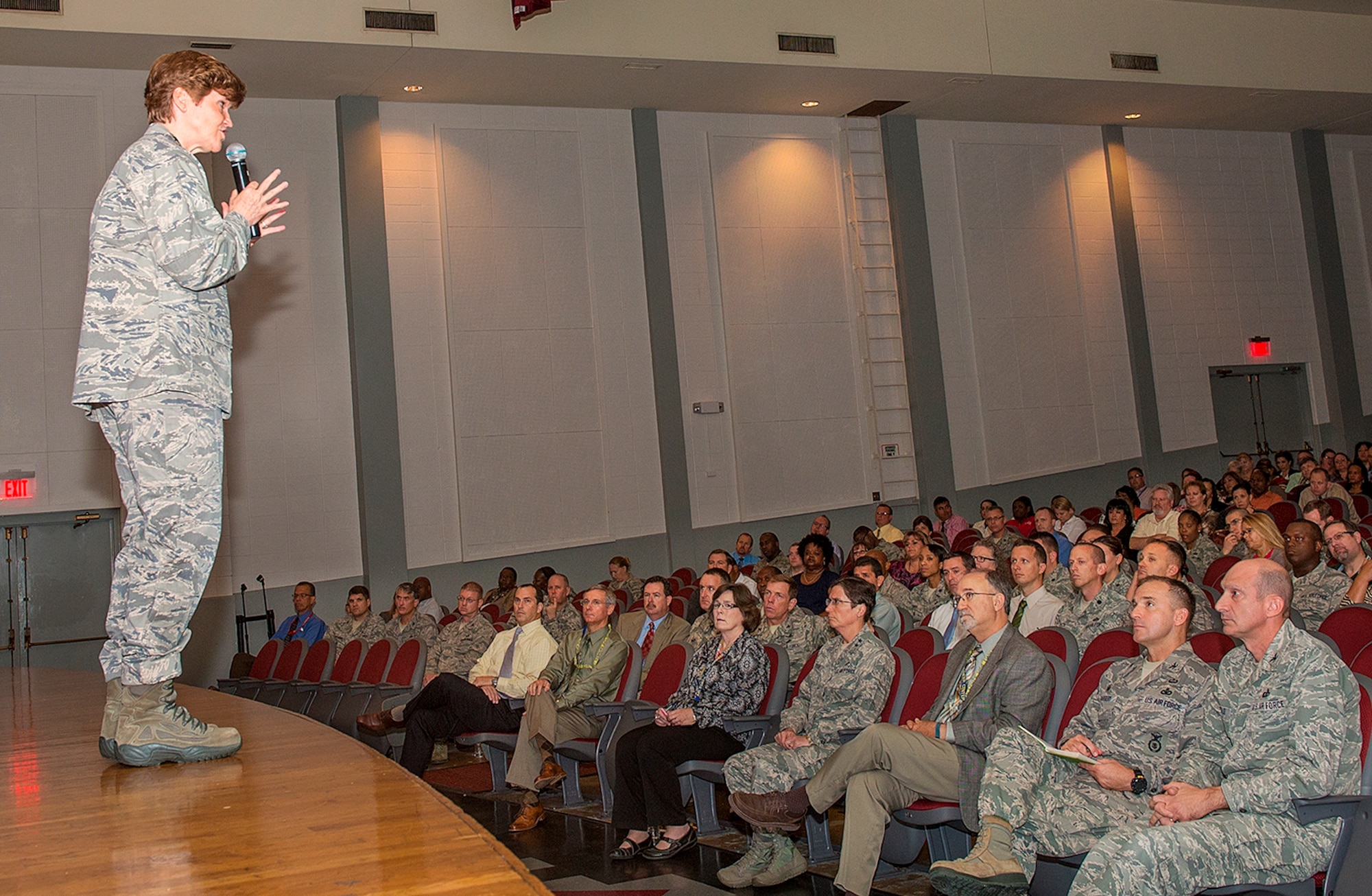 Gen. Janet Wolfenbarger, commander of Air Force Materiel Command, presents information about her command and the new Air Force Installation and Mission Support Center (Provisional) to about 400 members of the Air Force Civil Engineer Center, Air Force Security Forces Center, Air Force Materiel Command Services Directorate and local squadrons assigned to the Air Force Installation Contracting Agency Oct. 9 at a town hall meeting in the Bob Hope Theater at Joint Base San Antonio-Lackland, Tex. (U.S. Air Force photo/Benjamin Faske)