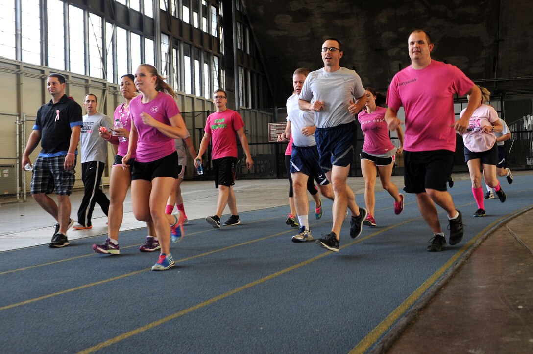 Airmen from the 28th Medical Group participate in the Breast Cancer Awareness Month walk-a-thon at the Pride Hangar at Ellsworth Air Force Base, S.D., Oct. 15, 2014. The base Health and Wellness Center hosted the event, which allowed Airmen to show their support for Breast Cancer Awareness, as well as breast cancer survivors and fighters. (U.S. Air Force photo by Senior Airman Hailey R. Staker/Released)