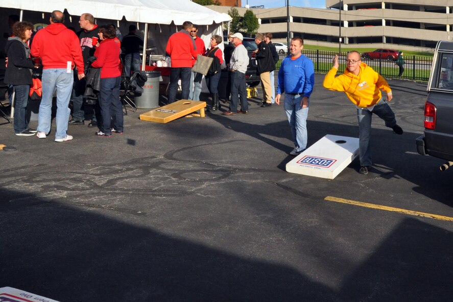 YOUNGSTOWN STATE UNIVERSITY, Ohio – Air Force Reserve Airman 1st Class Albert Schmalzreid, a trainee assigned to the 910th Airlift Wing Development and Training Flight, watches as Senior Airman Nicholas Bacisin, a personnel specialist assigned to the 910th Force Support Squadron, shows off his skills during a cornhole match at a tailgate picnic hosted by the 910th Airlift Wing here, October 11, 2014. More than 80 football fans representing the wing’s Citizen Airmen, along with their coworkers, families and friends enjoyed a tailgate picnic on a cool but sunny fall afternoon. The event, which has become a fall tradition in recent years for YARS personnel, was presented by the Youngstown Air Reserve Base Community and the USO of Northern Ohio. The 910th Force Support Squadron Outdoor Recreation Office and Community Activity Center staff also supported the event. U.S. Air Force photo by Master Sgt. Bob Barko Jr.