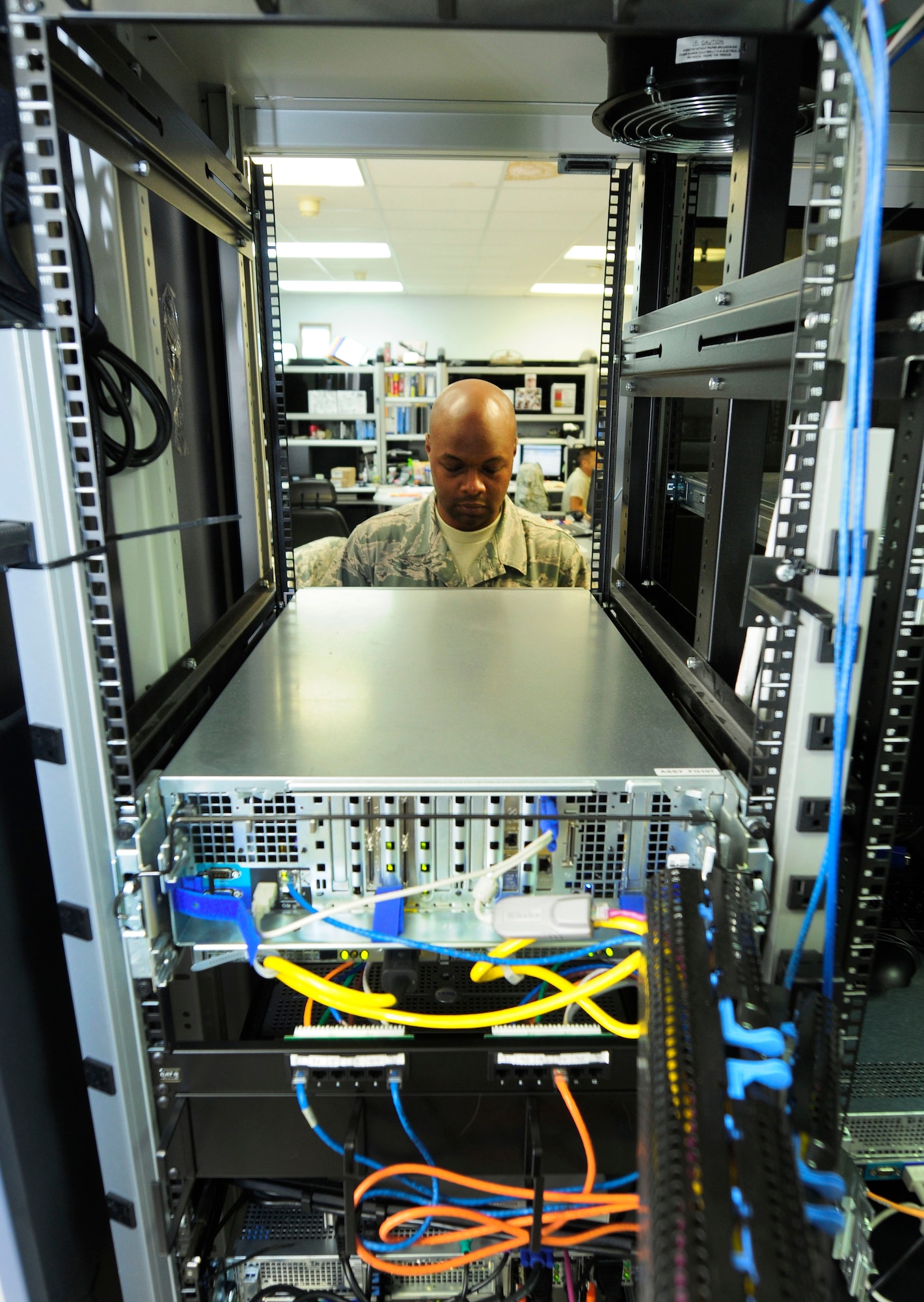 U.S. Air Force Tech. Sgt. Andre Corbett, client systems administrator for the 145th Communications Flight, applies new TIME Compliance Network Orders (TCNO) patching that  provides the level of security needed to complete mission tasking at the North Carolina Air National Guard base, Charlotte Douglas Intl. Airport, Oct. 1, 2014. Corbett makes sure that the security patches installed are working by accessing each server manually and looking for specific responses that would be given during an authorized access login and an unauthorized login. (U.S. Air National Guard photo by Master Sgt. Patricia F. Moran, 145th Public Affairs/Released)