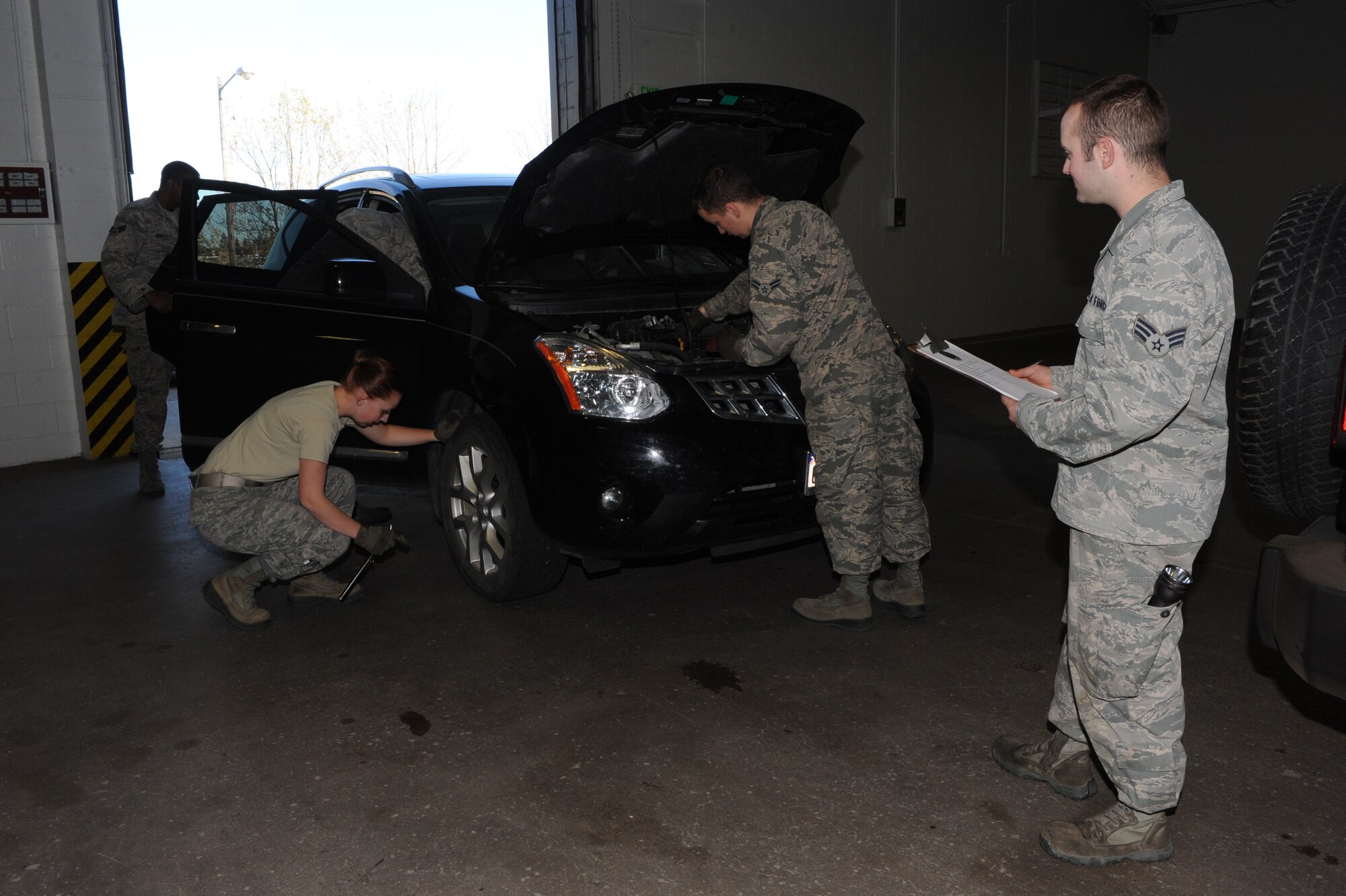 Members of the 5th Logistics Readiness Squadron conduct vehicle inspections on Minot Air Force Base, N.D., Oct. 10, 2014. The inspections were conducted in conjunction with a safety awareness day on base which covered topics such as safe winter driving and vehicle weatherization. (U.S. Air Force photo/Senior Airman Stephanie Morris)