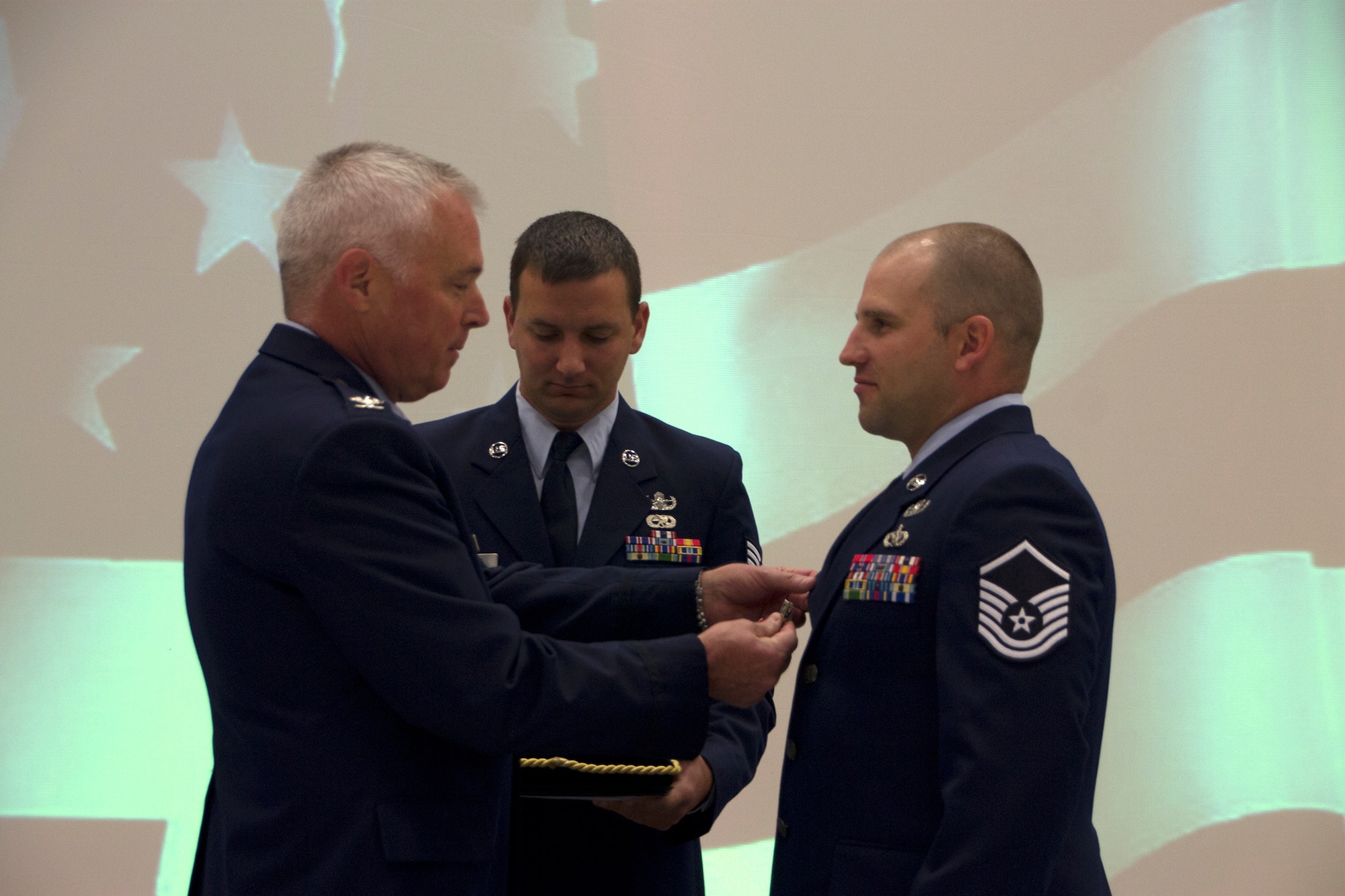 Col. Scott McLaughlin (left), 446th Airlift Wing commander presenting Master Sgt. Shawn Lundgren, 446th Civil Engineer Squadron, explosive ordnance disposal technician, with the Bronze Star Medal, Oct. 5, 2014. Lundgren earned the award for his actions while serving in Afghanistan, October 2013 to May 2014. (U.S. Air Force Reserve photo by Staff Sgt. Bryan Hull)