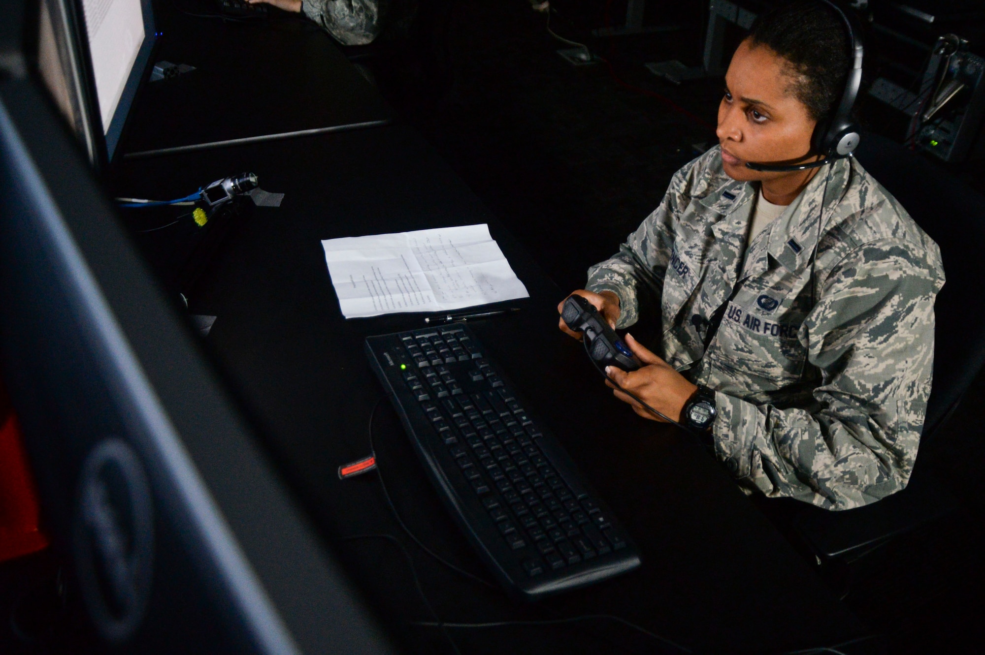 U.S. Air Force 1st Lt. Kristin Spencer, 711th Human Performance Wing behavioral scientist, watches a video for suspicious behavior during a demonstration of a new Enhanced Reporting, Narrative Event Streaming Tool developed by the Air Force Research Lab, Oct. 15, 2014, at Wright-Patterson Air Force Base, Ohio.  The program aims to make intelligence analyst’s jobs easier by streamlining some of their routine tasks which could enable to them save more lives. (U.S. Air Force photo by Wesley Farnsworth)