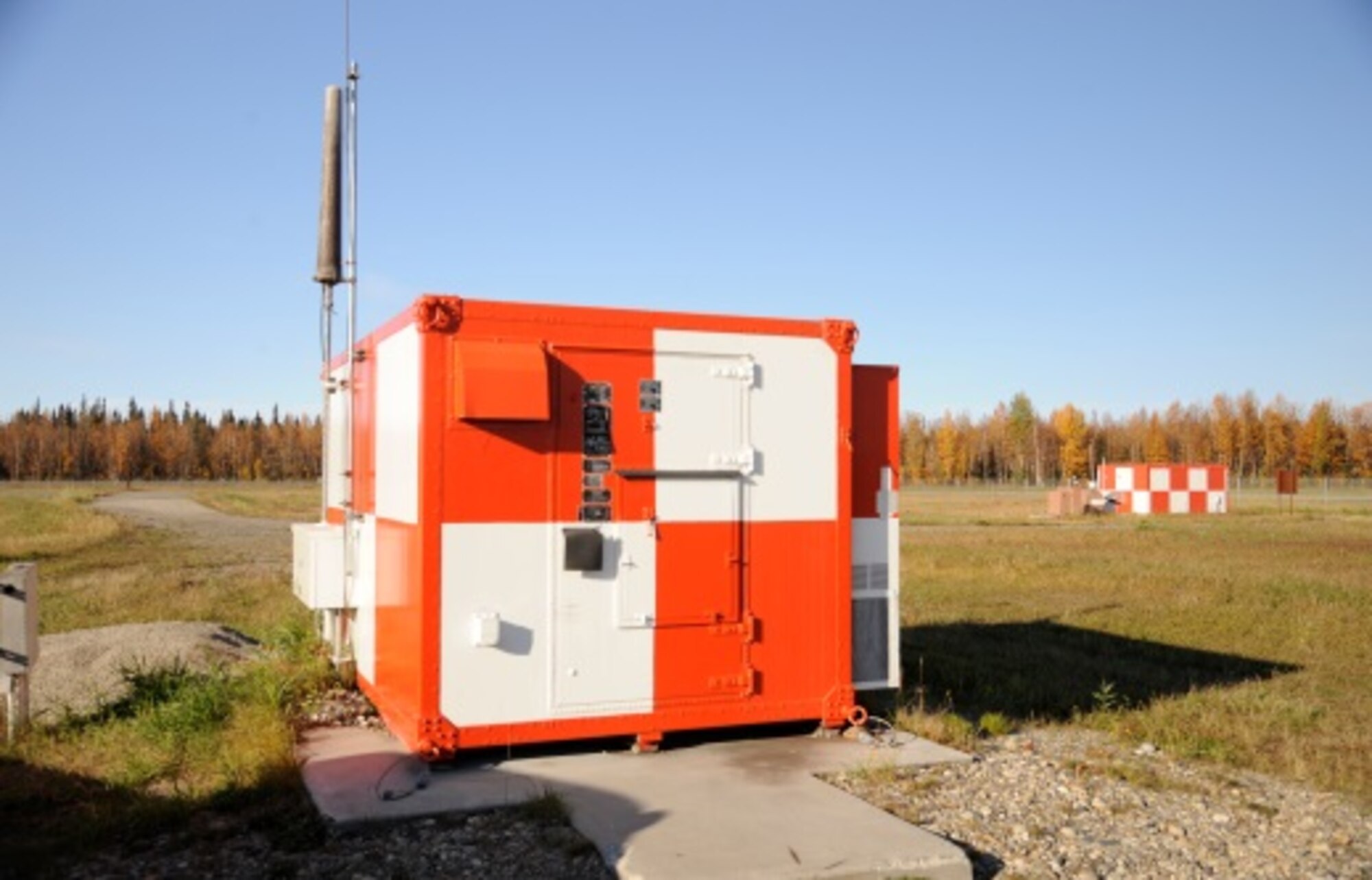 In 2012, the cyber arm of the U.S. Air Force identified the ground radar and airfield systems career fields for transfer as a cyber-specialty to an operations support specialty that joins the airfield management community. The 354th Communications Squadron will transfer authority of airfield systems like this localizer shelter which transmits a radio signal to approaching aircraft to aid in landing, to the 354th Operations Support Squadron in October, Eielson Air Force Base, Alaska. (U.S. Air Force photo by Staff Sgt. Kirsten Wicker/Released) 