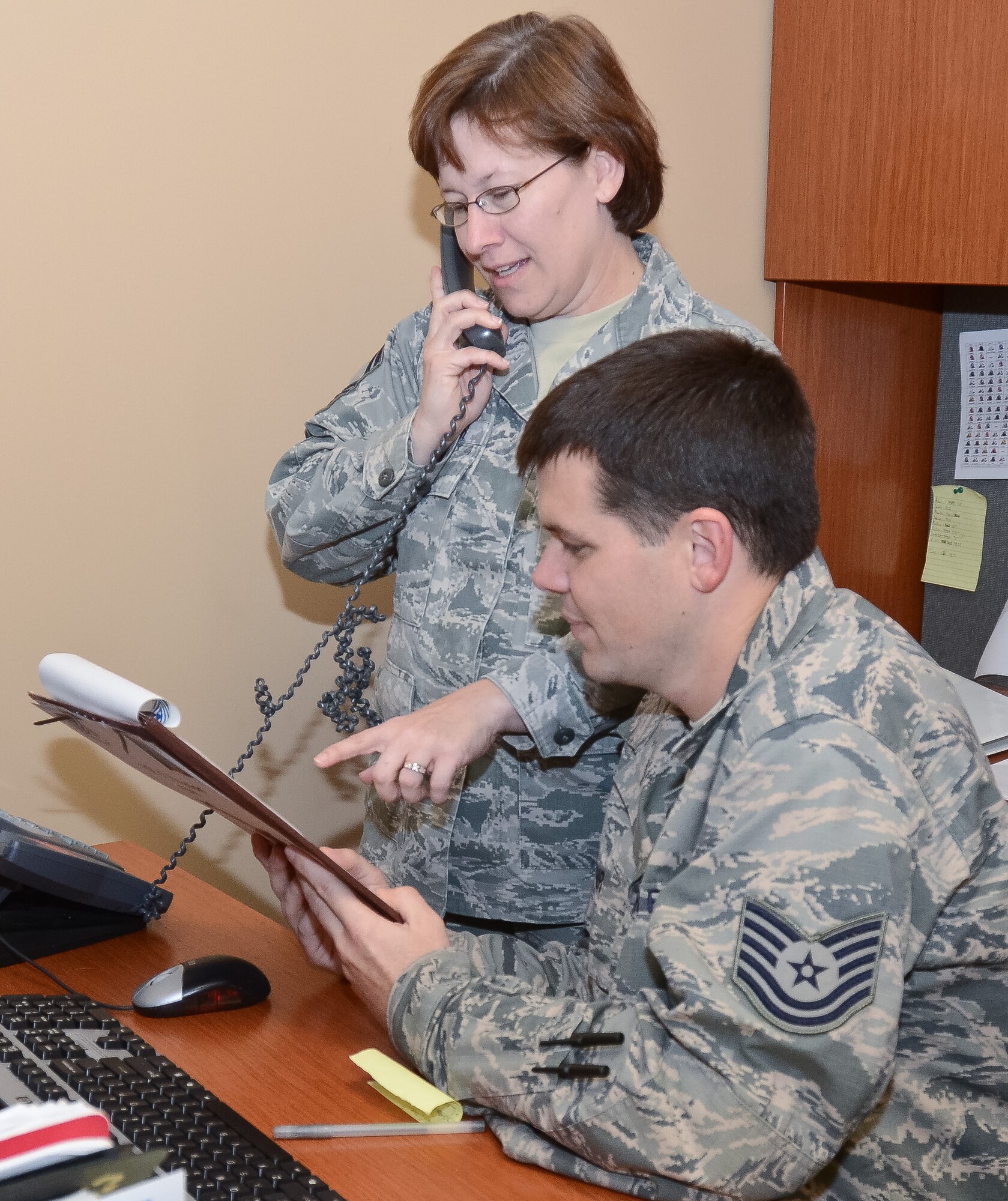 U.S. Air Force Senior Master Sgt. Merissa Mueller, left, and Tech. Sgt. Adam Adair with the 116th Logistics Readiness Squadron Deployment Distribution Flight, Georgia Air National Guard, review pre-deployment checklists during a Unit Training Assembly at Robins Air Force Base, Ga. Oct. 19, 2014. These logistics planners are part of a six-member team that are responsible for implementing plans to move people, cargo and military assets downrange.  When personnel return home from deployment, the planners switch gears to the reintegration phase of their job, ensuring all members have the necessary resources for a successful transition. (U.S. Air National Guard photo by Senior Airman Kari Giles/Released)