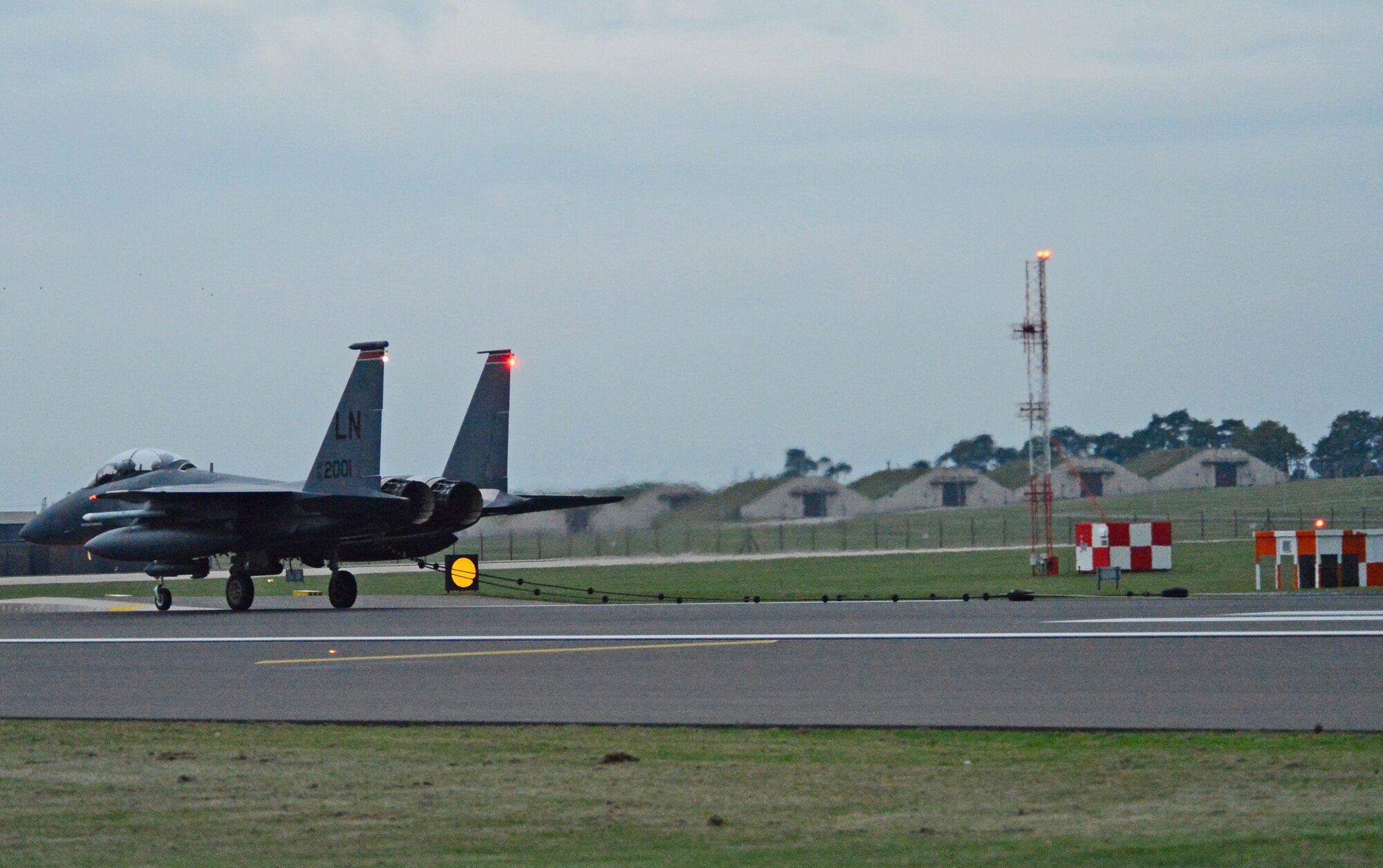 Firefighters assigned to the 48th Civil Engineer Squadron rush over to a 494th Fighter Squadron F-15E Strike Eagle after the aircraft encountered a barrier engagement system as part of the certification process on the runway at Royal Air Force Lakenheath, England, Oct. 15, 2014. The cables are strategically placed along the runway to stop aircraft if hydraulic systems or brakes fail. (U.S. Air Force photo by Airman 1st Class Erin O’Shea/Released) 