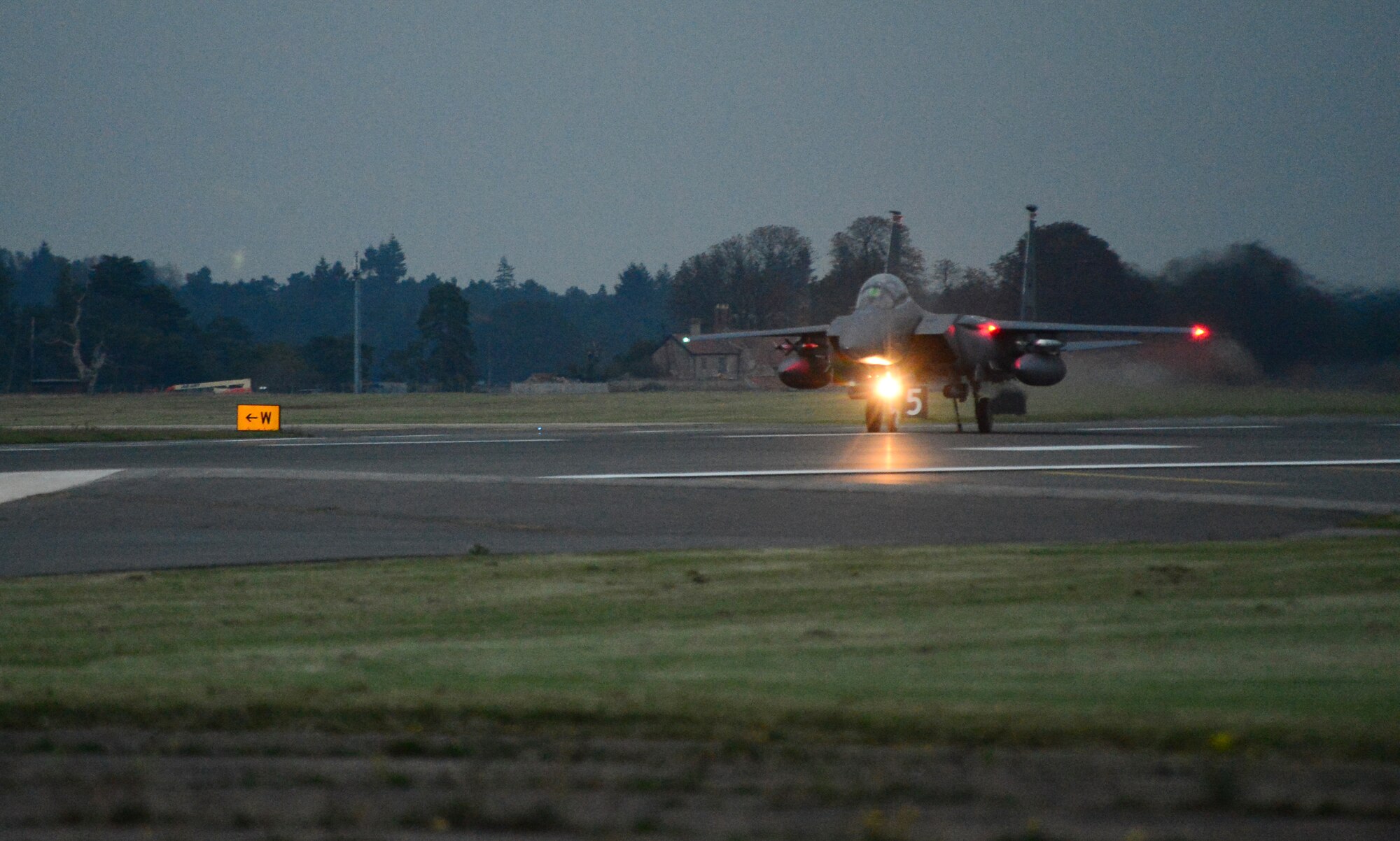 An F-15E Strike Eagle assigned to the 494th Fighter Squadron catches a cable during the certification process of a new aircraft arrest barrier engagement system on the runway at Royal Air Force Lakenheath, England, Oct. 15, 2014. The cables are strategically placed along the runway to stop aircraft if hydraulic systems or brakes fail. (U.S. Air Force photo by Airman 1st Class Erin O’Shea/Released) 