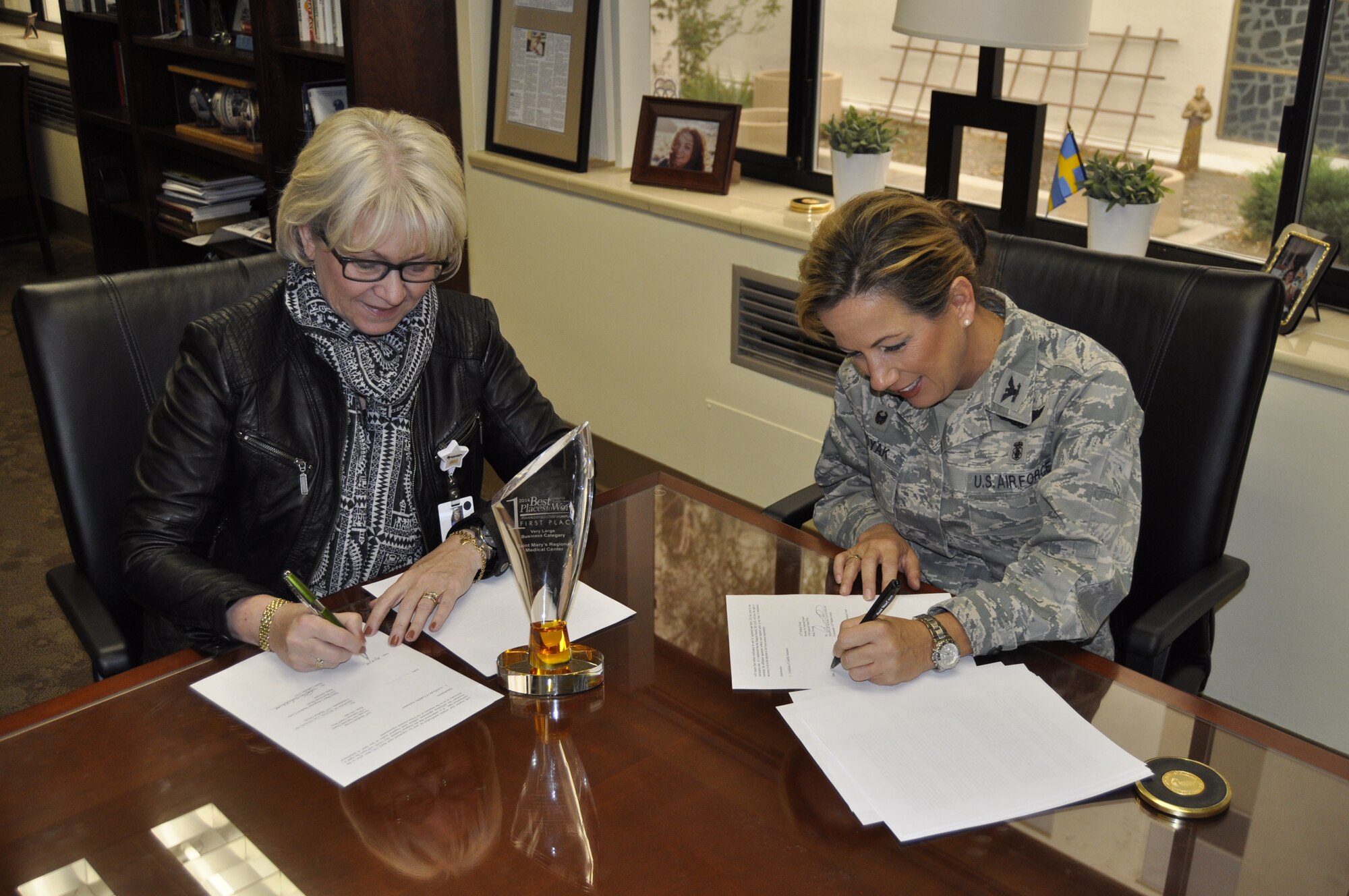 Helen Lidholm (left), CEO of St. Mary’s Regional Medical Center here in Reno, and Col. Shanna Woyak, 152nd Medical Group Commander, sign a Training Affiliation Agreement (TAA) between the 152nd Medical Group and St. Mary’s.  The TAA will allow medical technicians from the 152nd Med Group to perform hands-on medical training, under staff supervision, at St. Mary's.  U.S. Air Force photo by Capt. Jason Yuhasz. (RELEASED) 
