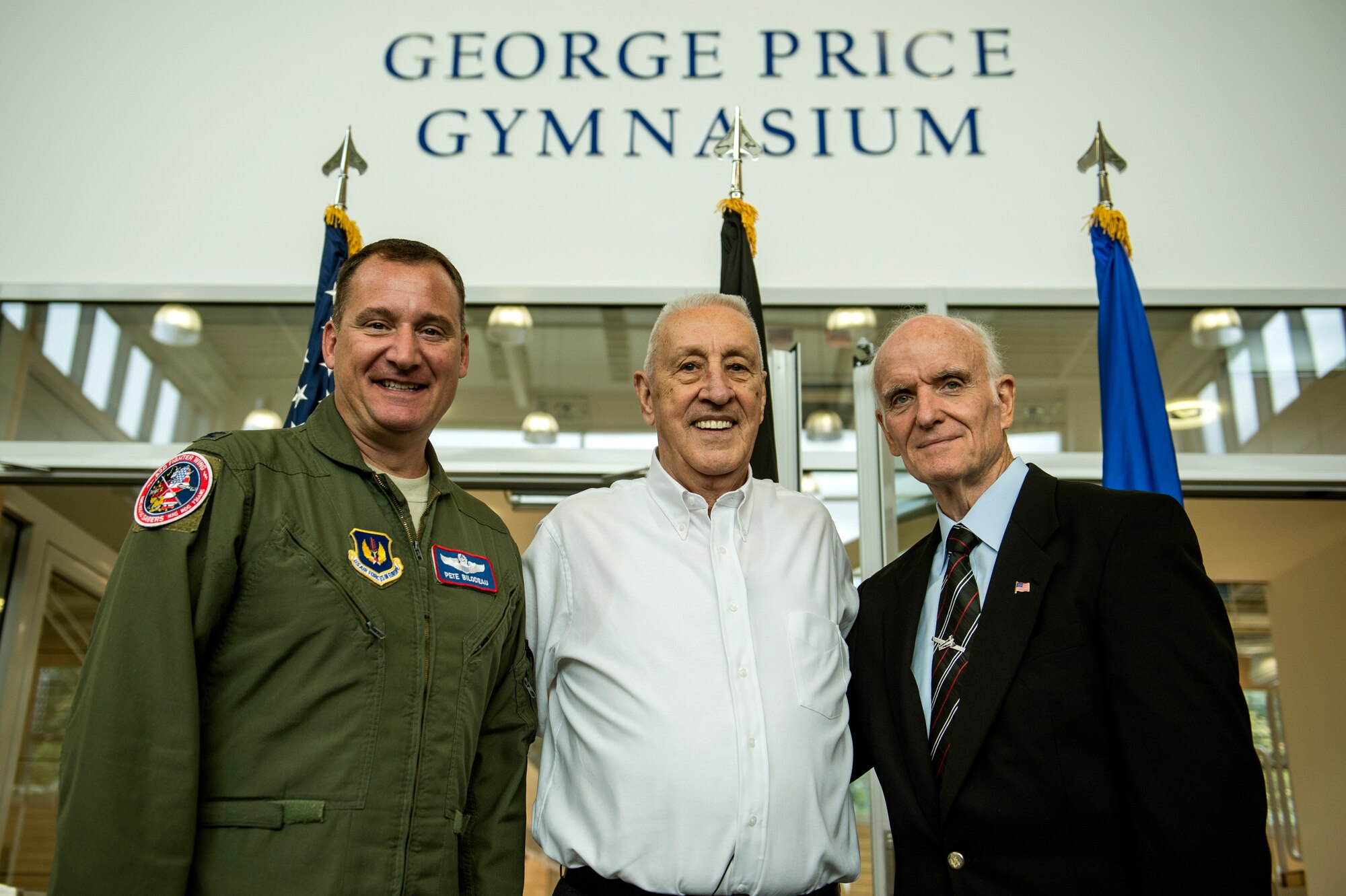 U.S. Air Force Col. Pete Bilodeau, 52nd Fighter Wing commander, left, George Price 52nd Force Support Squadron special events coordinator, center, Arthur Meyers, former senior executive service principal director of military community and family policy for the Office of the Under Secretary of Defense, right, pose for a photo in front of the newly dedicated George Price Gymnasium, inside the Eifel Power Haus fitness center, Oct. 16, 2014, at Spangdahlem Air Base, Germany. Price became the first civilian to be inducted into the U.S. Air Forces in Europe and Air Forces Africa sports hall of fame. (U.S. Air Force photo by Senior Airman Rusty Frank/Released)