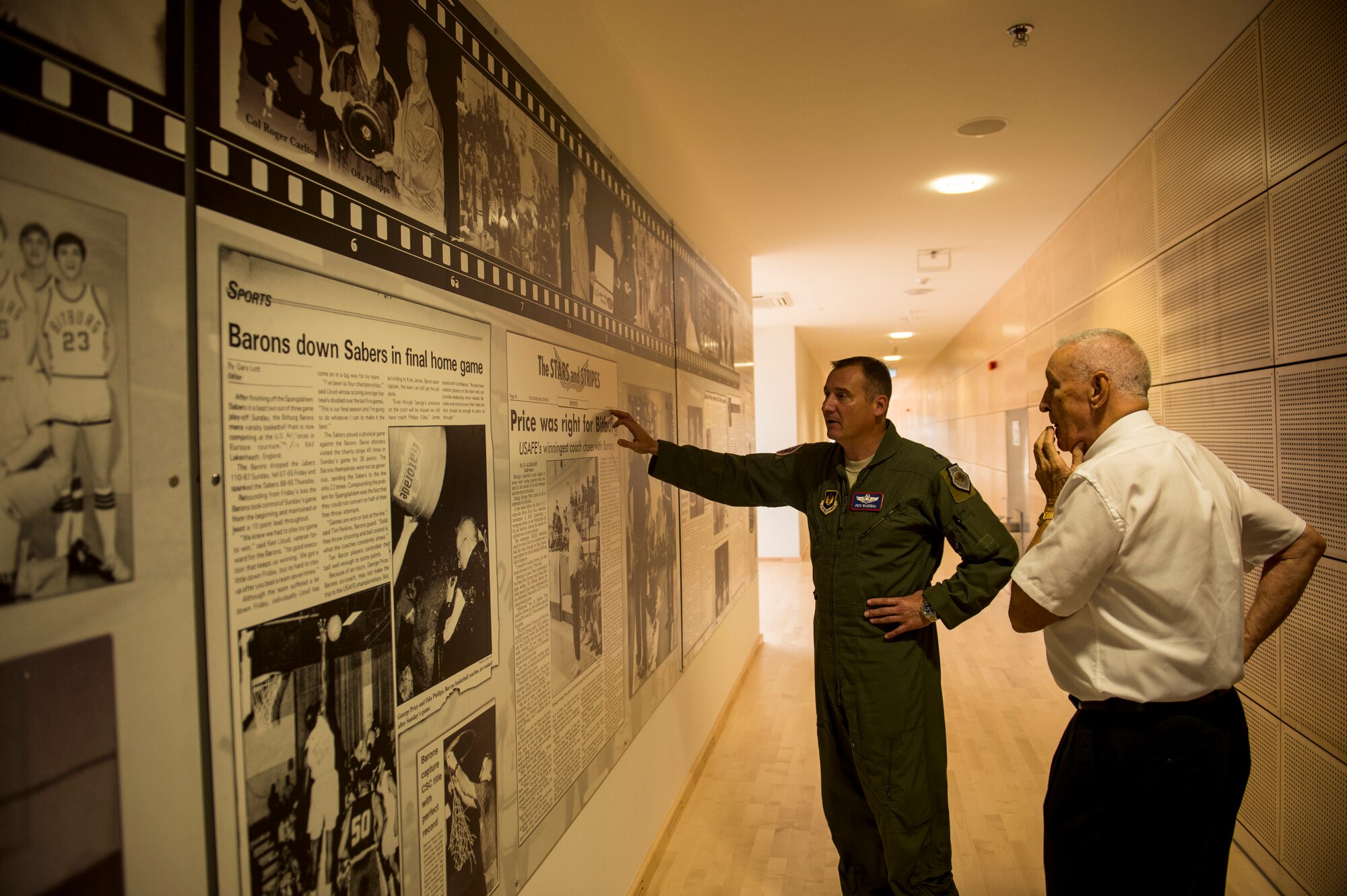 U.S. Air Force Col. Pete Bilodeau, 52nd Fighter Wing commander, looks at a mural dedicated to George Price, 52nd Force Support Squadron special events coordinator, after a dedication ceremony Oct. 16, 2014, at Spangdahlem Air Base, Germany. Base leadership hosted the ceremony to rename the gymnasium inside the Eifel Power Haus fitness center in Price’s honor. (U.S. Air Force photo by Senior Airman Rusty Frank/Released)