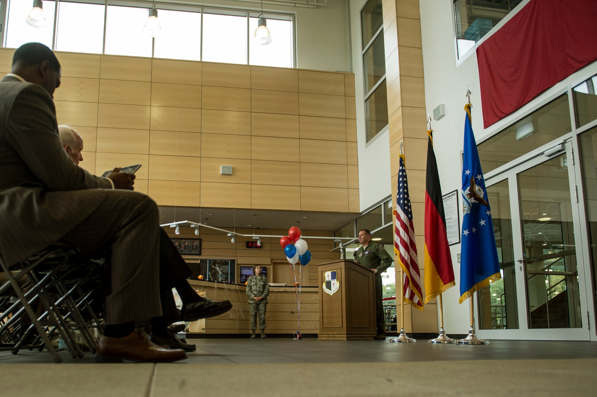 U.S. Air Force Col. Pete Bilodeau, 52nd Fighter Wing commander, speaks during a dedication ceremony to honor George Price, 52nd Force Support Squadron special events coordinator, inside the Eifel Power Haus Oct. 16, 2014, at Spangdahlem Air Base, Germany. The ceremony honored Price's decades of service to the U.S. Air Force and the Spangdahlem-Bitburg community. (U.S. Air Force photo by Senior Airman Rusty Frank/Released)