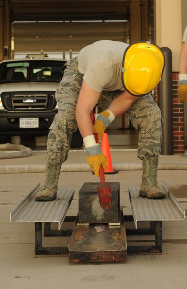 U.S. Air Force 1st Lt. Dustin Gooden, 7th Civil Engineer Squadron section commander, hits a keiser sled during the Firefighter Challenge Oct. 10, 2014, at Dyess Air Force Base, Texas. Keiser sleds are a training tool used by firefighters to simulate forcible entry specifically in the event of a fire. It was used during the Firefighter challenge to give other units the chance to experience training that firefighters undergo. (U.S. Air Force photo by Airman 1st Class Autumn Velez/Released) 