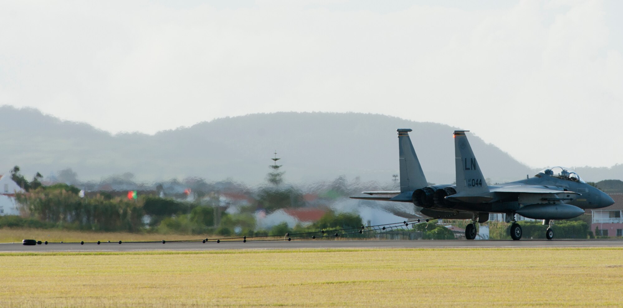 An F-15 Eagle from Royal Air Force Lakenheath, England, catches a pendant to test and certify the 65th Air Base Wing’s barrier arresting kit on Lajes Field, Azores, Portugal, Oct. 17, 2014. The barrier arresting kit certification is an annual requirement and is designed to prevent a crash during emergency situations. (U.S. Air Force photo by Tech. Sgt. Bradley C. Church).
