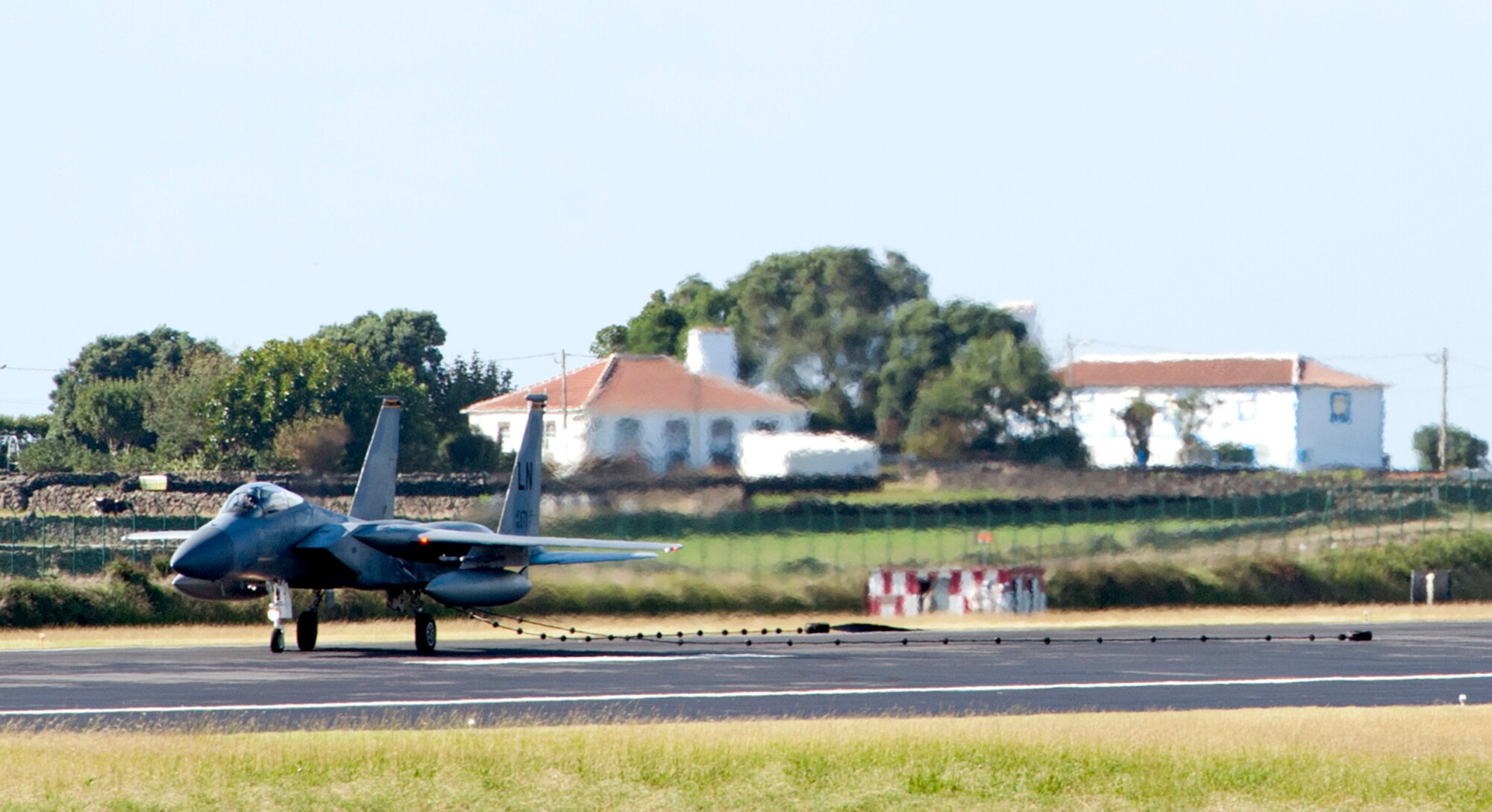 An F-15 Eagle from Royal Air Force Lakenheath, England, catches a pendant to test and certify the 65th Air Base Wing’s barrier arresting kit on Lajes Field, Azores, Portugal, Oct. 17, 2014. The barrier arresting kit certification is an annual requirement and is designed to prevent a crash during emergency situations. (U.S. Air Force photo by Tech. Sgt. Bradley C. Church).
