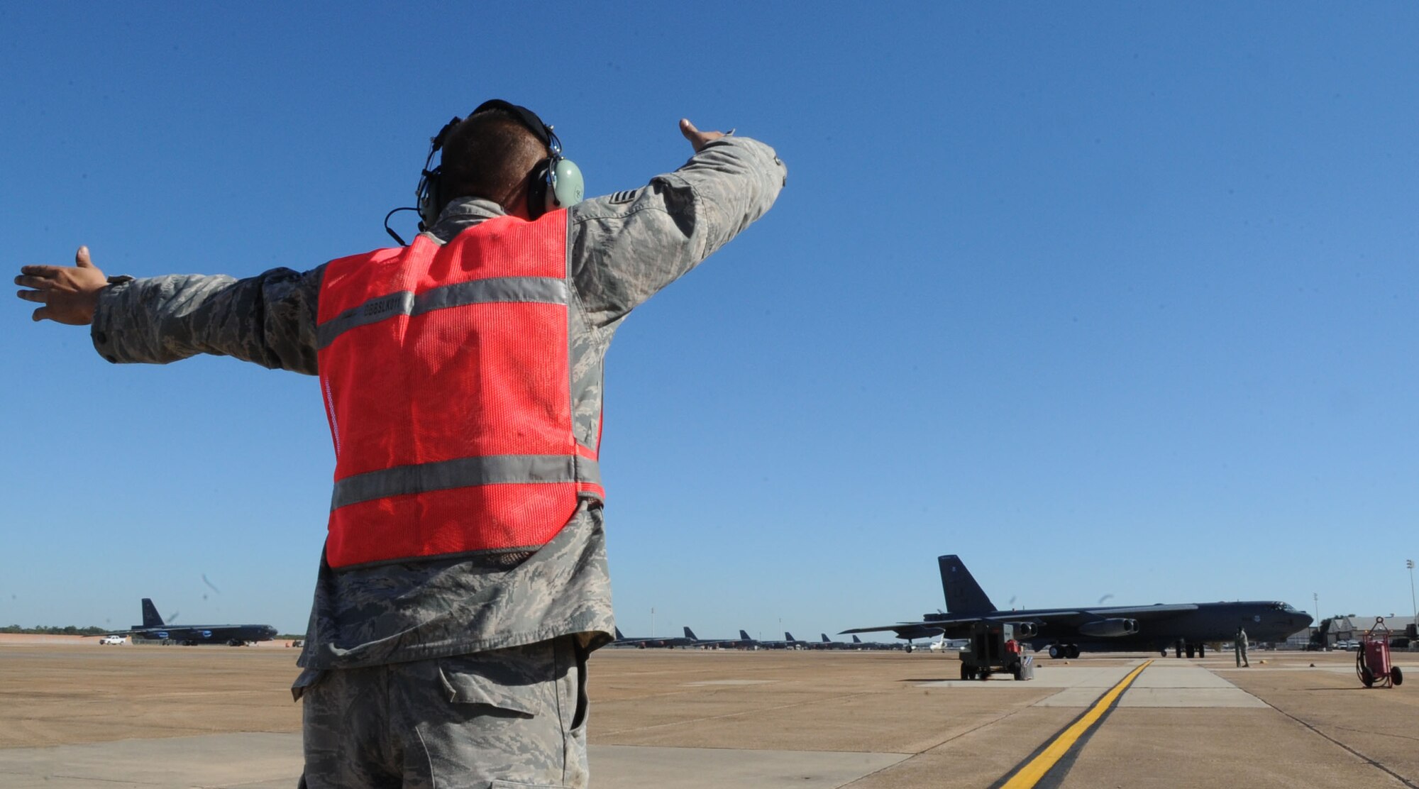 Senior Airman Anthony Mitchell II, 307th Maintenance Squadron crew chief, marshals in a B-52H Stratofortress on Barksdale Air Force Base, La., Oct. 16, 2014. Under Secretary of the Air Force Eric Fanning participated in a training flight aboard the aircraft during his visit to Barksdale to get a better understanding of the deterrence mission and the B-52H Stratofortress capabilities. (U.S. Air Force photo/Senior Airman Kristin High)