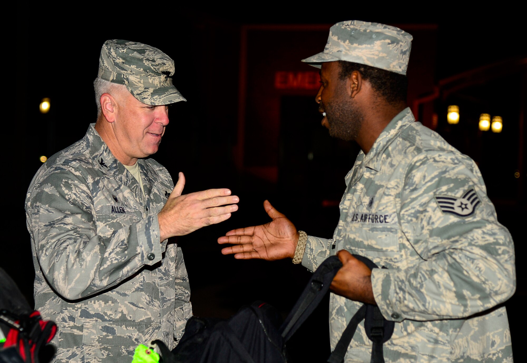 U.S. Air Force Col. John J. Allen Jr., 633rd Air Base Wing commander, greets Staff Sgt. Thomas Wright, 633rd Medical Operations Squadron ultrasound noncommissioned officer in charge, at Langley Air Force Base, Va., Oct. 20, 2014. Members of the 633rd MDOS returned after constructing an expeditionary field hospital for the U.S. Public Health Service in West Africa. (U.S. Air Force photo by Senior Airman Kayla Newman/Released)