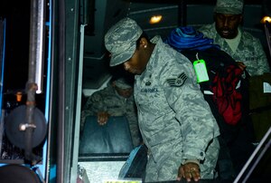 U.S. Air Force Airmen assigned to the 633rd Medical Group exit a bus in front of USAF Hospital Langley at Langley Air Force Base, Va., Oct. 20, 2014. Airmen returned from setting up an Expeditionary Medical Support System in West Africa as part of Operation United Assistance. (U.S. Air Force photo by Senior Airman Kayla Newman/Released)