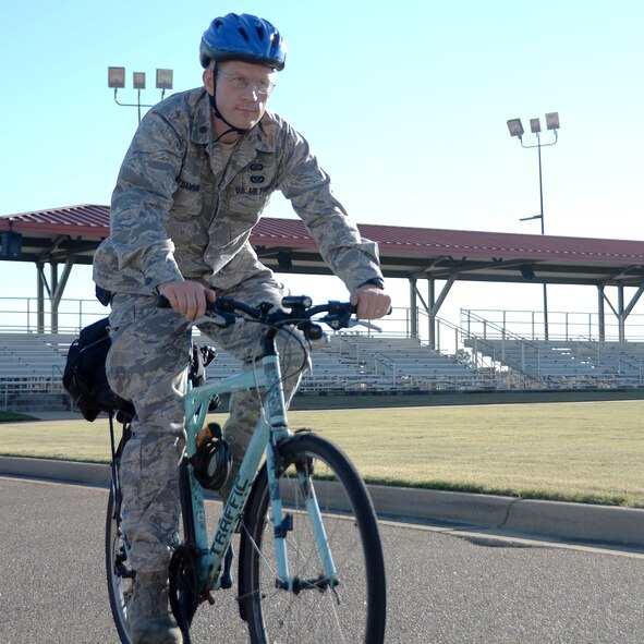 Maj. David Dawson, Air Force Officer Training School director of staff, rides his bicycle after work Oct. 17, 2014. For more than two decades Dawson has made the personal choice to ride his bicycle to and from work every day. (U.S. Air Force photo by/Staff Sgt. Erica Picariello)