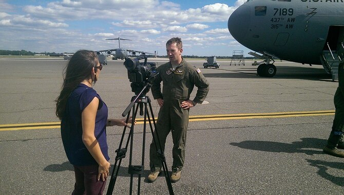 A local reporter from WCBD Charleston Channel 2 news interviews Capt. Chance Harridge, 317th Airlift Squadron, on the Joint Base Charleston, S.C. flight line about his role as an aircraft commander for one of several Operation United Assistance airlift missions, flown by Charleston Reservists earlier this month to West Africa - the front lines of the fight against Ebola. Now as efforts are stepped up, President Barack Obama has authorized the Defense Department to call up a small number of National Guard or reserve troops that possess special skills needed to aid efforts in stopping the spread of the deadly Ebola virus in West Africa.  (U.S. Air Force photo by Michael Dukes)
