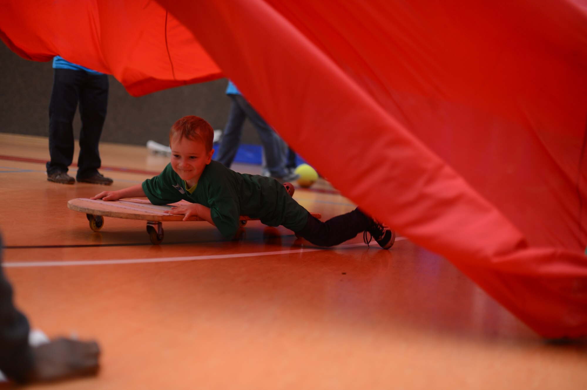 Leo Ohlenschlaeger, 5, a child from St. Martin School plays on a roller board in the Skelton Memorial Fitness Center on Spangdahlem Air Base, Germany, Oct. 16, 2014. More than 80 children from St. Martin School in Bitburg visited Spangdahlem Air Base. (U.S. Air Force photo by Senior Airman Gustavo Castillo/Released) 