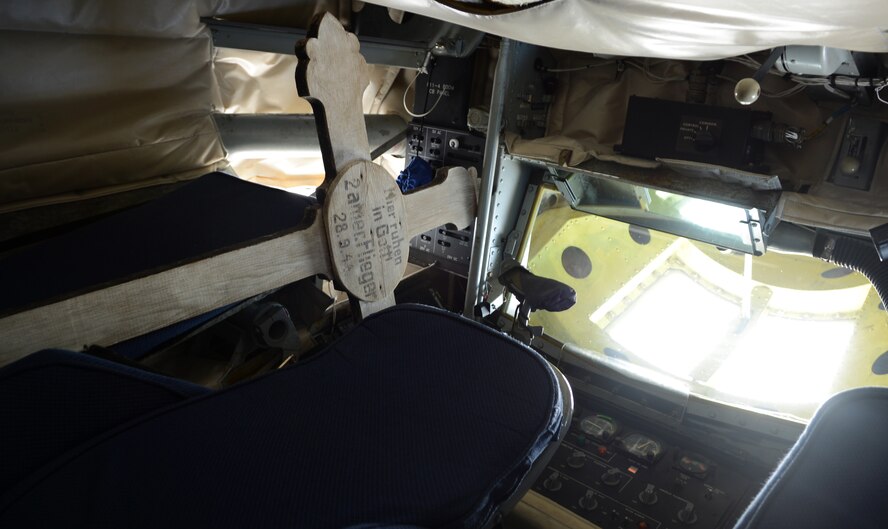 A grave marker for U.S. Army Air Corps 1st Lt. Raymond Harney and U.S. Army Air Corps 2nd Lt. Warren French rests in a boom pod of a KC-135 Stratotanker Oct. 14, 2014, over Germany. The cross was crafted to honor the lives of the two 100th Bombardment Group Airmen after their B-17 Flying Fortress crashed near the village of Schwickershausen, Germany, Sept. 28, 1944. (U.S. Air Force photo/Airman 1st Class Dillon Johnston/Released)