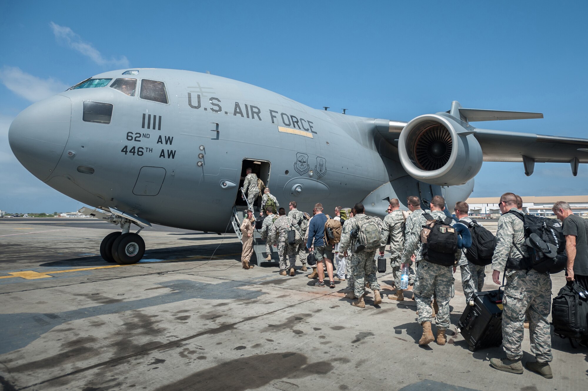A group of 30 U.S. military personnel, including Marines, Airmen, and Soldiers from the 101st Airborne Division, board a U.S. Air Force C-17 Globemaster III at Léopold Sédar Senghor International Airport in Dakar, Senegal, Oct. 19, 2014. The service members are bound for Monrovia, Liberia, where U.S. troops will construct medical treatment units and train health care workers as part of Operation United Assistance, the U.S. Agency for International Development-led, whole-of-government effort to respond to the Ebola outbreak in West Africa. (U.S. Air National Guard photo by Maj. Dale Greer)