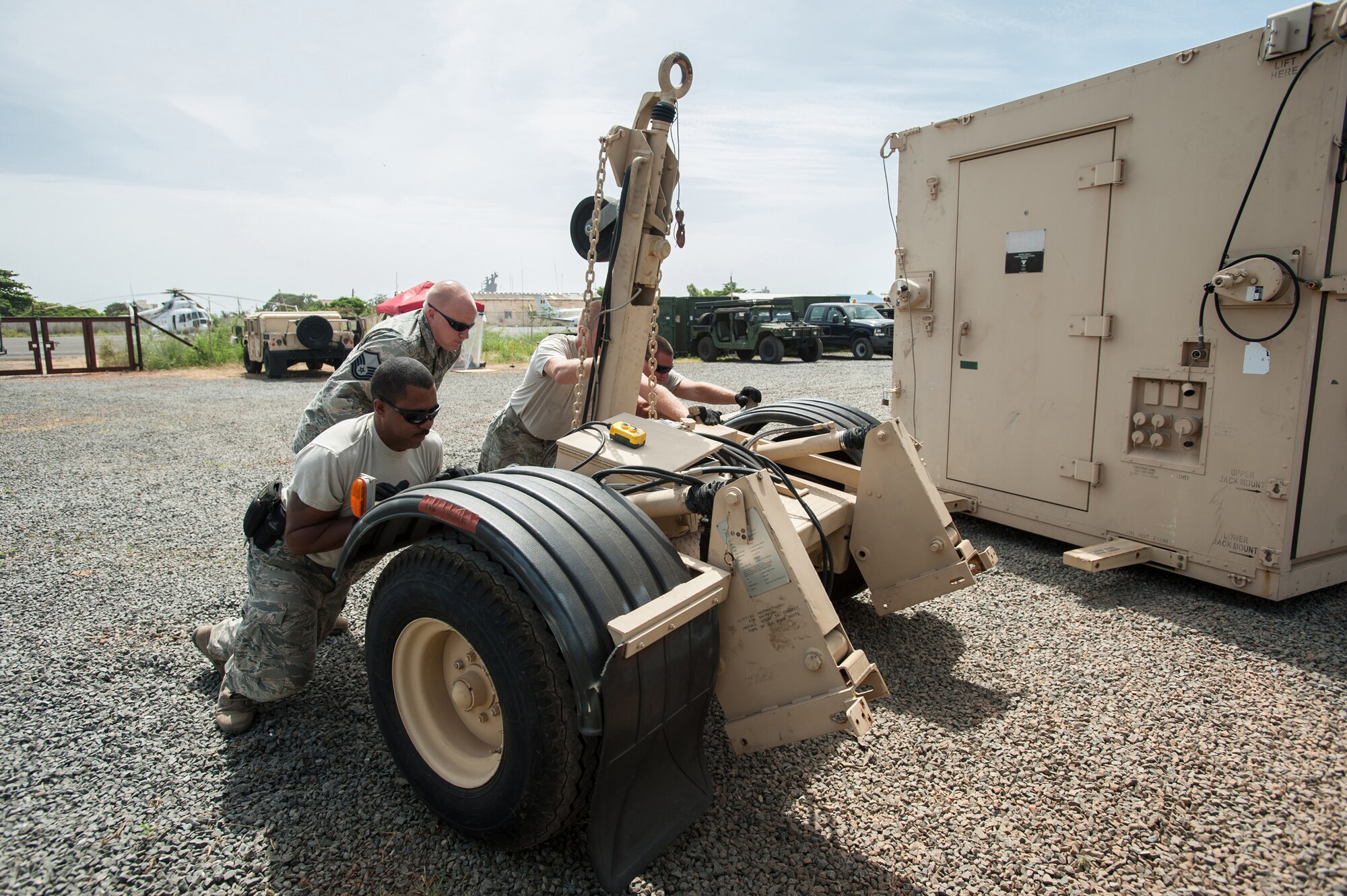 Airmen from the Kentucky Air National Guard’s 123rd Contingency Response Group remove the transport wheels from a mobile airfield operations center at Léopold Sédar Senghor International Airport in Dakar, Senegal, Oct. 17, 2014, in support of Operation United Assistance, the U.S. Agency for International Development-led, whole-of-government effort to respond to the Ebola outbreak in West Africa. The Airmen are operating an Intermediate Staging Base in Dakar to funnel humanitarian aid and military support equipment into affected areas, working in concert with Soldiers from the U.S. Army’s 689th Rapid Port Opening Element to staff a Joint Task Force-Port Opening. (U.S. Air National Guard photo by Maj. Dale Greer)