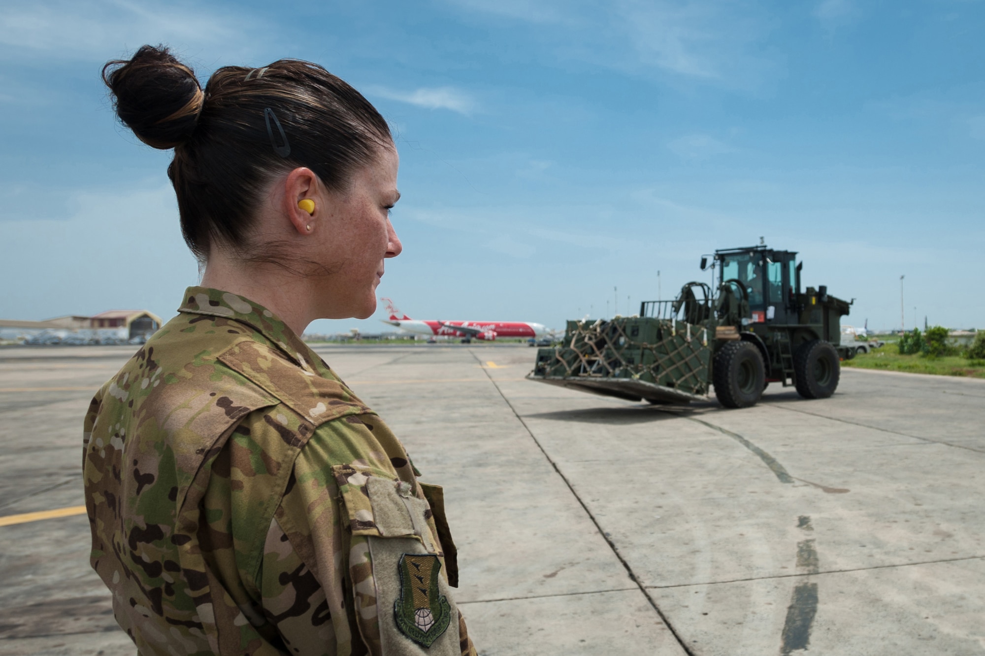 U.S. Air Force Tech. Sgt. Meghan Donahue, a member of a fly-away security detail from the 435th Air Expeditionary Wing at Ramstein Air Base, Germany, provides overwatch of a Ramstein C-130 Hercules aircraft as U.S. Air Force Senior Airman Alex Vincent, an aerial porter from the Kentucky Air National Guard’s 123rd Contingency Response Group, prepares to load a pallet of red blood cells and frozen plasma on the aircraft Oct. 10, 2014, at Léopold Sédar Senghor International Airport in Dakar, Senegal. The Airmen are supporting Operation United Assistance, the U.S. Agency for International Development-led, whole-of-government effort to respond to the Ebola outbreak in West Africa. (U.S. Air National Guard photo by Maj. Dale Greer)