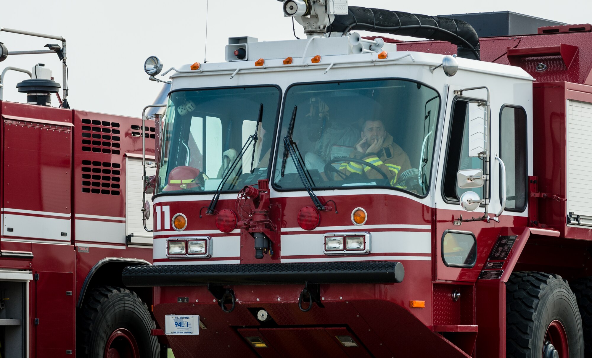 A firefighter waits inside his fire engine as part of a major accident response exercise on Ramstein Air Base, Germany, Oct. 18, 2014. Members of the Air Force and host nation agencies partnered in conducting a response and recovery in preparation for possible real-world incidents. (U.S. Air Force photo/Airman 1st Class Jordan Castelan)