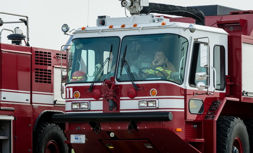 A firefighter waits inside his fire engine as part of a major accident response exercise on Ramstein Air Base, Germany, Oct. 18, 2014. Members of the Air Force and host nation agencies partnered in conducting a response and recovery in preparation for possible real-world incidents. (U.S. Air Force photo/Airman 1st Class Jordan Castelan)