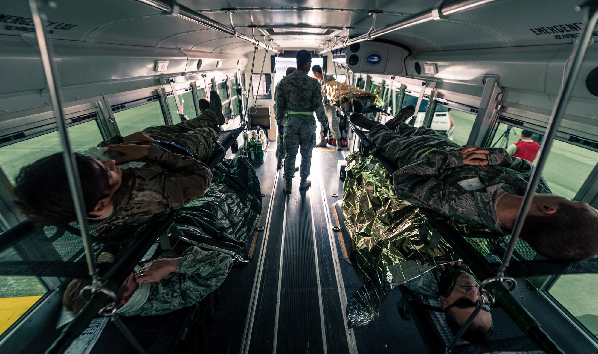 Four Airmen wait to be transported to receive additional simulated medical attention as part of a major accident response exercise on Ramstein Air Base, Germany, Oct. 18, 2014. Members of the Air Force and host nation agencies partnered in conducting a response and recovery in preparation for possible real-world incidents. (U.S. Air Force photo/Airman 1st Class Jordan Castelan)