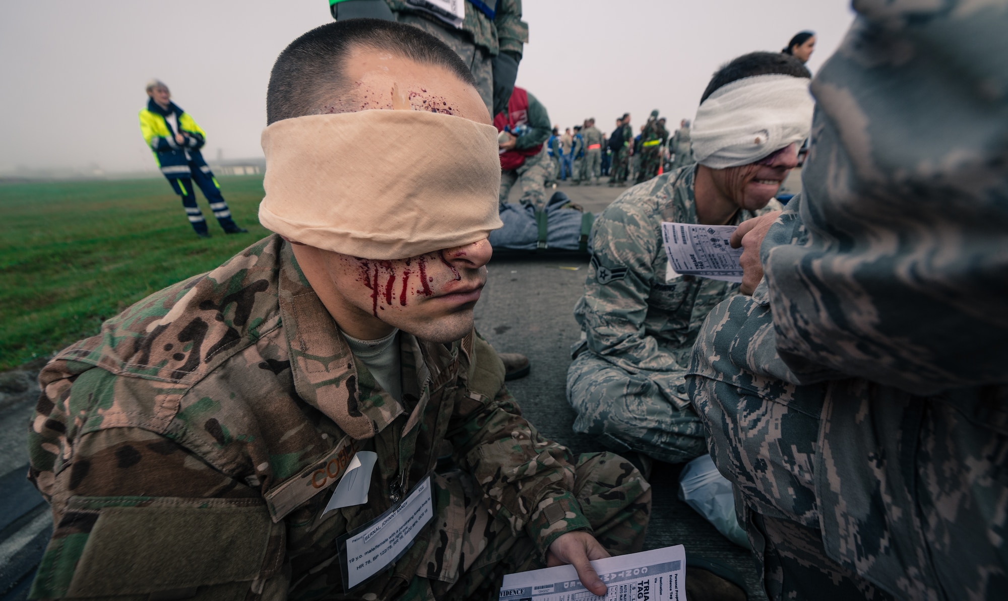 Senior Airman Jeremy Coble, 786th Civil Engineer Squadron heating ventilation and air conditioning technician, waits to be transported to receive additional simulated medical attention as part of a major accident response exercise on Ramstein Air Base, Germany, Oct. 18, 2014. Members of the Air Force and host nation agencies partnered in conducting a response and recovery in preparation for possible real-world incidents. (U.S. Air Force photo/Airman 1st Class Jordan Castelan)