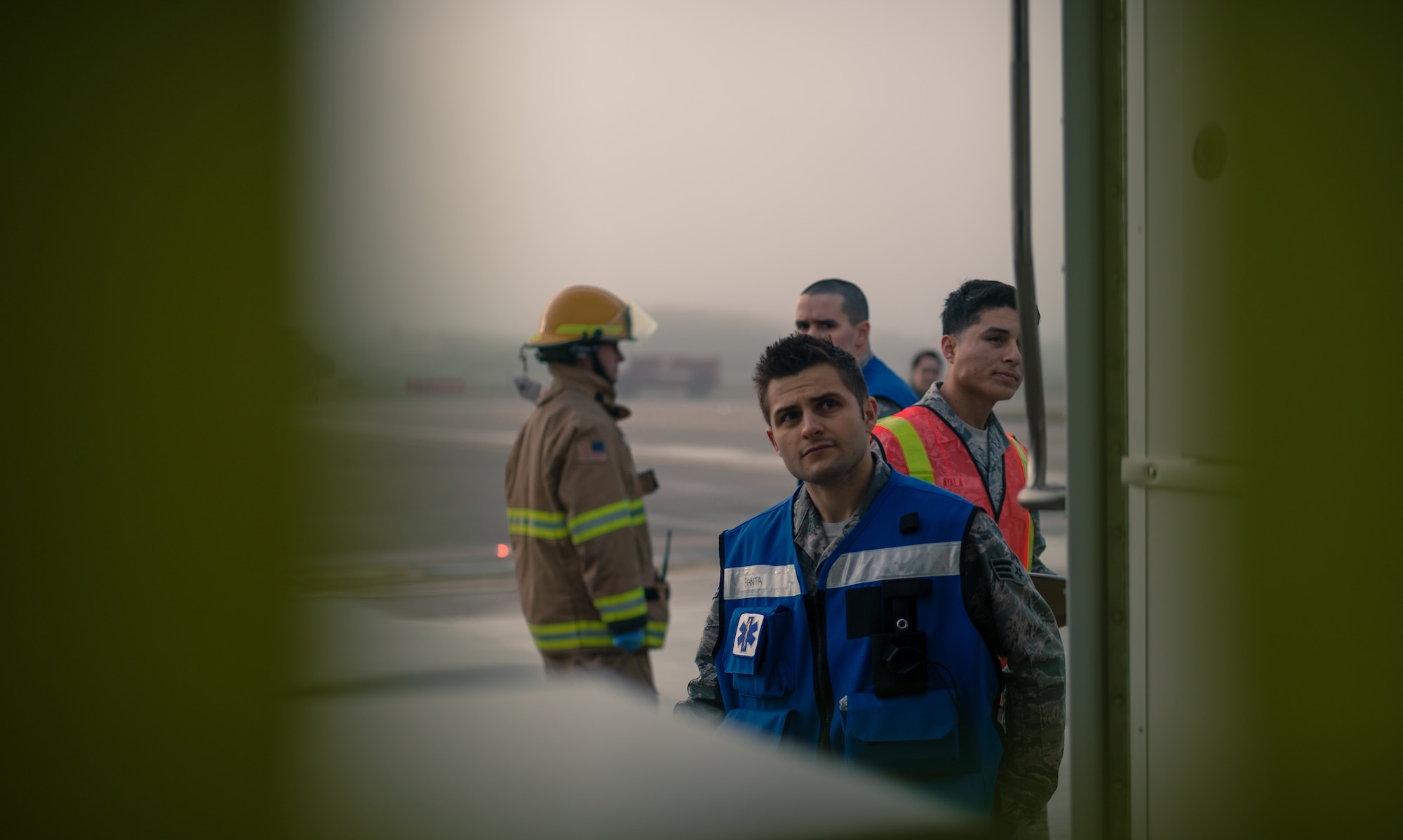 Senior Airman Ashton Banta, 86th Medical Operations Squadron ambulance service technician, looks into the rear of his ambulance while a simulated injured passenger is cared for as part of a major accident response exercise on Ramstein Air Base, Germany, Oct. 18, 2014. Members of the Air Force and host nation agencies partnered in conducting a response and recovery in preparation for possible real-world incidents. (U.S. Air Force photo/Airman 1st Class Jordan Castelan)